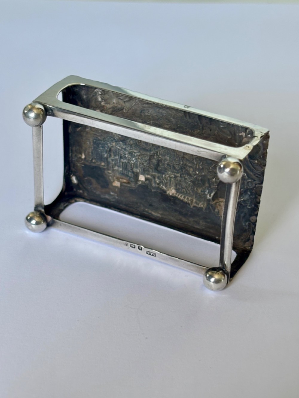 A rectangular silver matchbox cover featuring an embossed relief depicting Windsor Castle surrounded by scrollwork borders. View XIV
