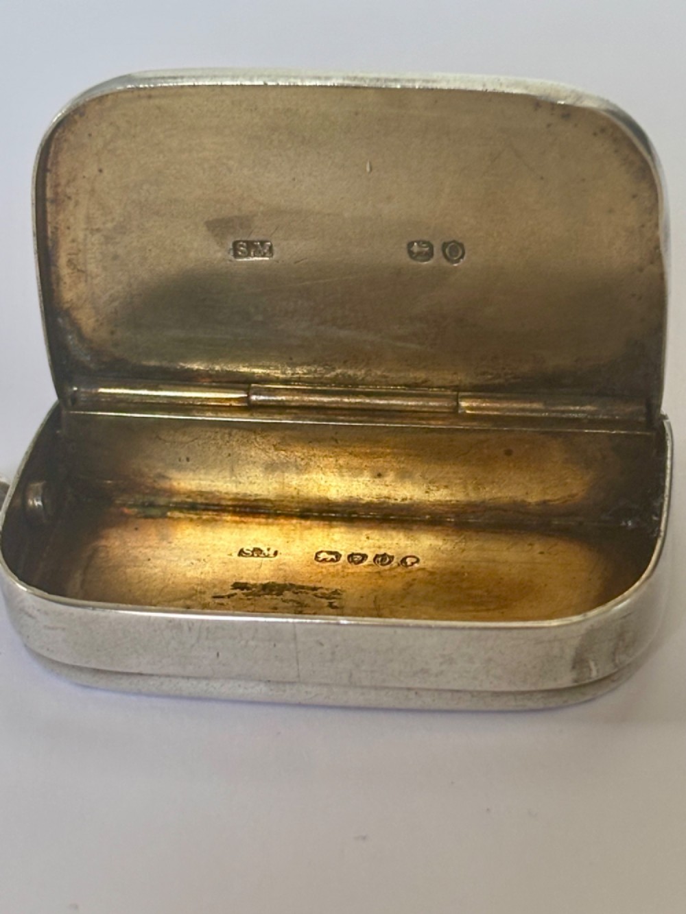 A small rectangular Victorian silver vesta case featuring horizontal reeded engine-turned decoration and an attached side suspension ring. View IV