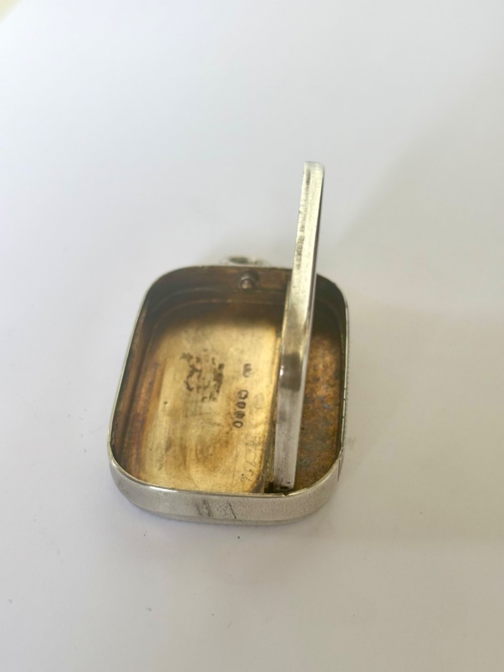 A small rectangular Victorian silver vesta case featuring horizontal reeded engine-turned decoration and an attached side suspension ring. View VII