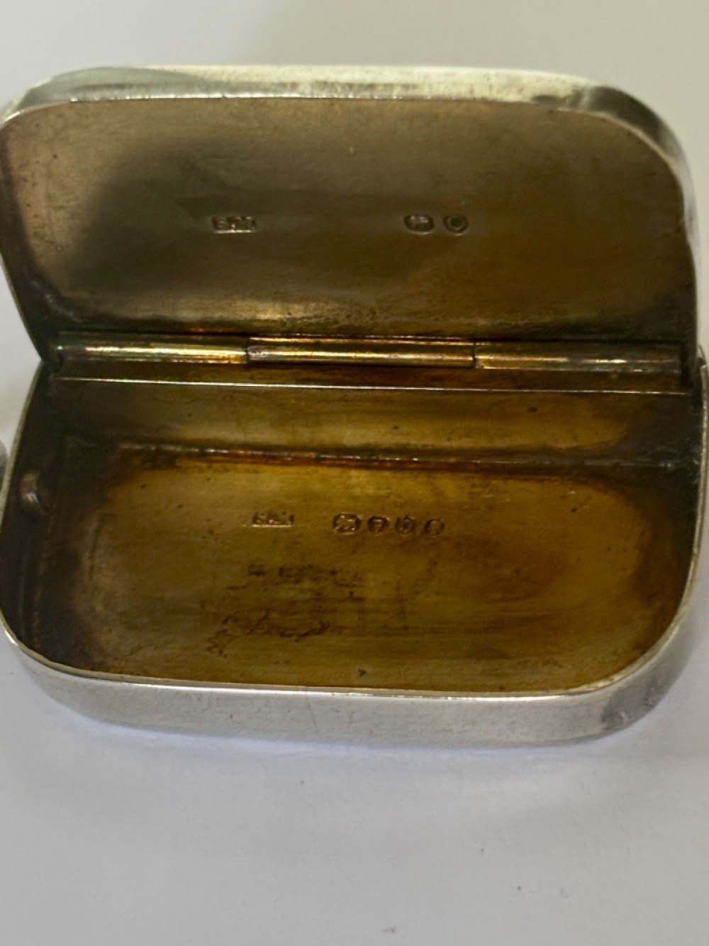 A small rectangular Victorian silver vesta case featuring horizontal reeded engine-turned decoration and an attached side suspension ring. View X