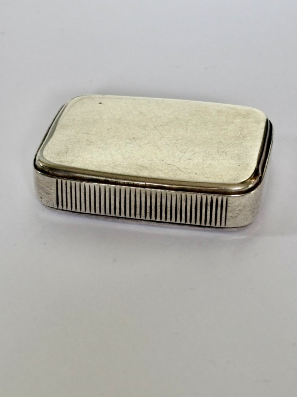 A small rectangular Victorian sterling silver vesta case with rounded corners and reeded sides.
