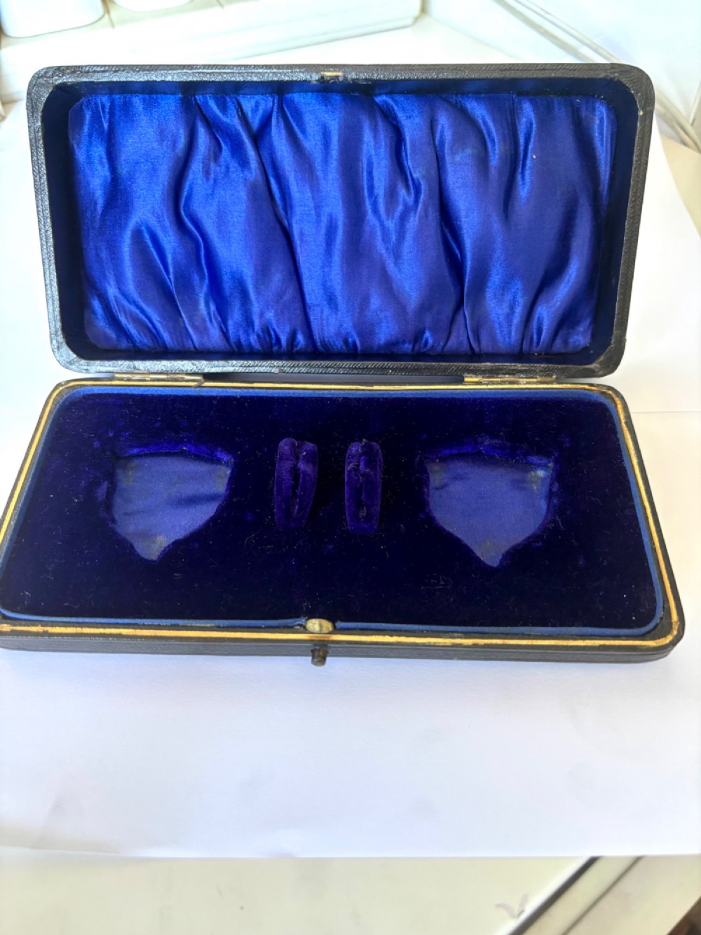 An open fitted presentation case containing two shell-shaped silver salt cellars with gilded interiors and two matching shell-bowl spoons. View X