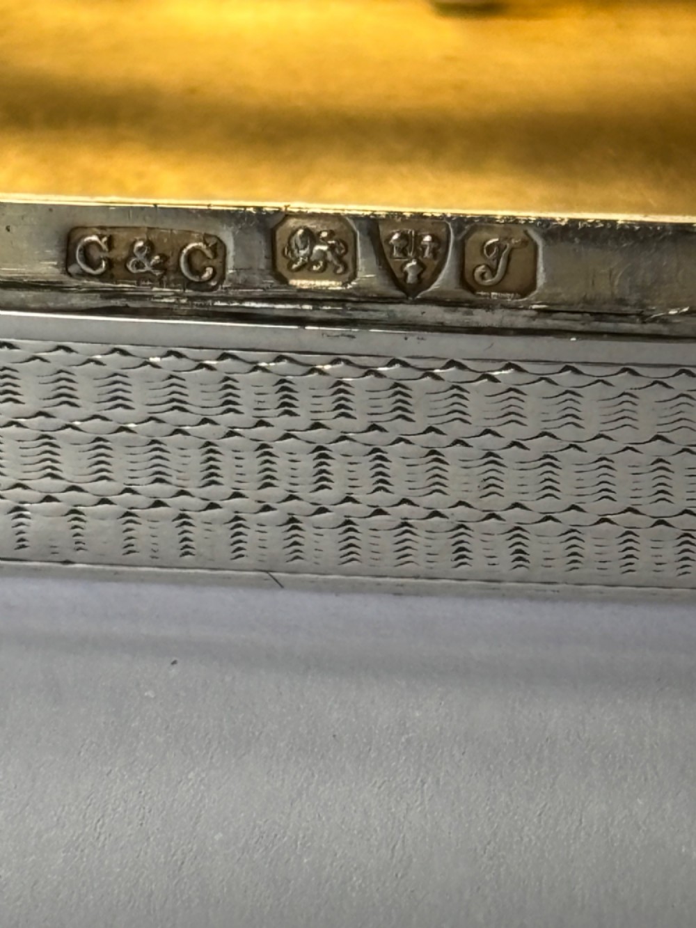 A small rectangular sterling silver snuff box with engine-turned basketweave engraving and a hinged lid. View III