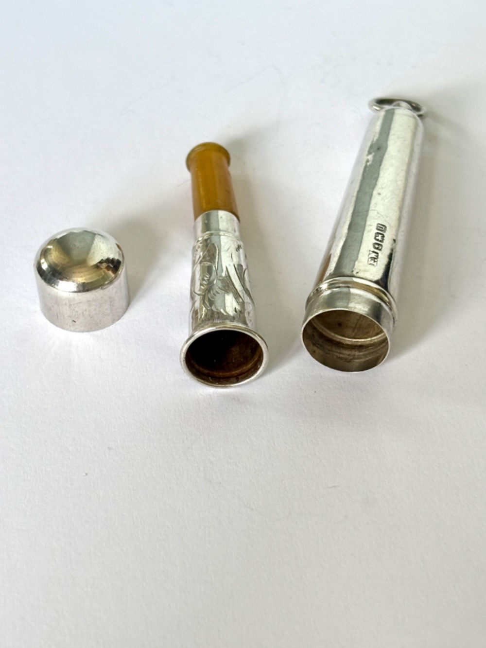 A George V sterling silver cheroot holder case with scroll engraving and a fitted amber mouthpiece. View III