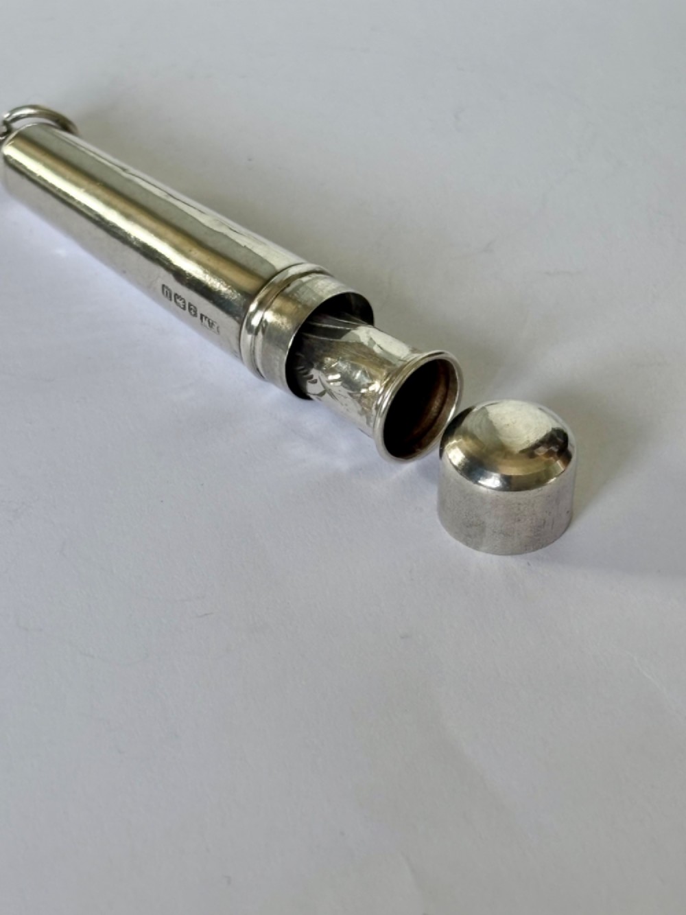 A George V sterling silver cheroot holder case with scroll engraving and a fitted amber mouthpiece. View IV