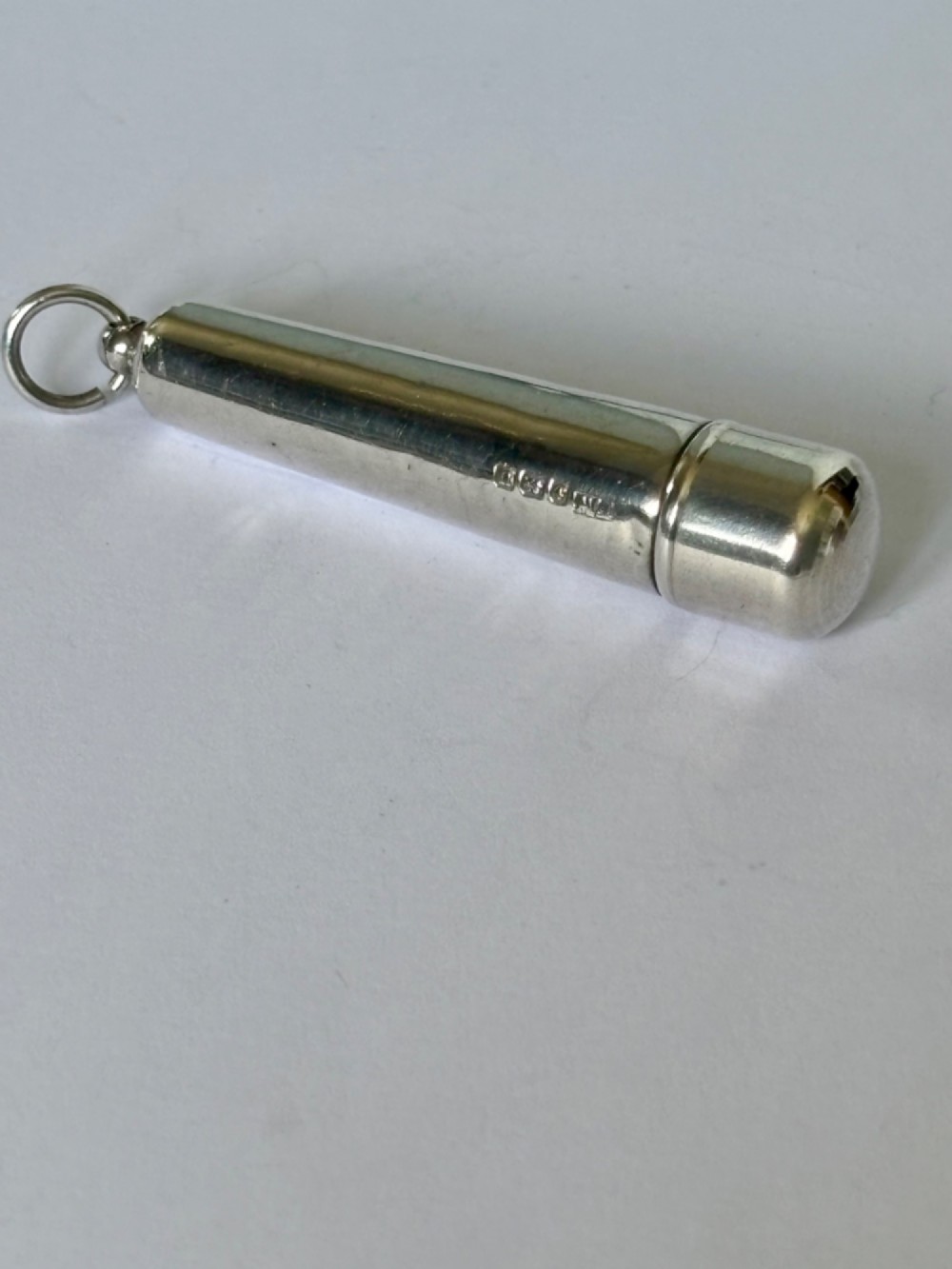 A George V sterling silver cheroot holder case with scroll engraving and a fitted amber mouthpiece. View VII