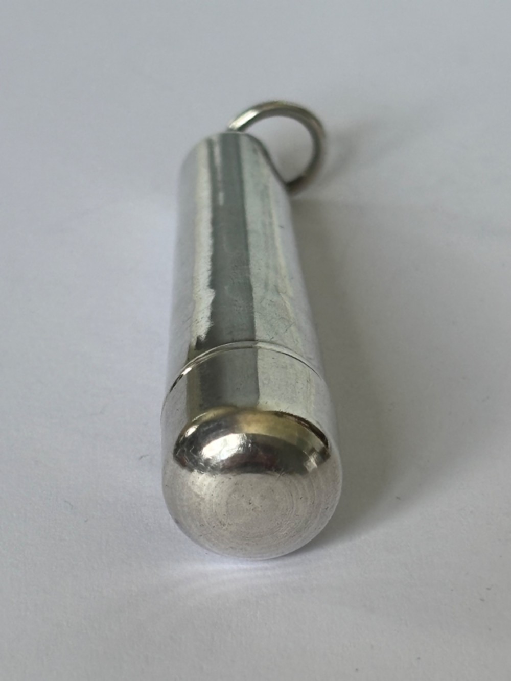 A George V sterling silver cheroot holder case with scroll engraving and a fitted amber mouthpiece. View IX