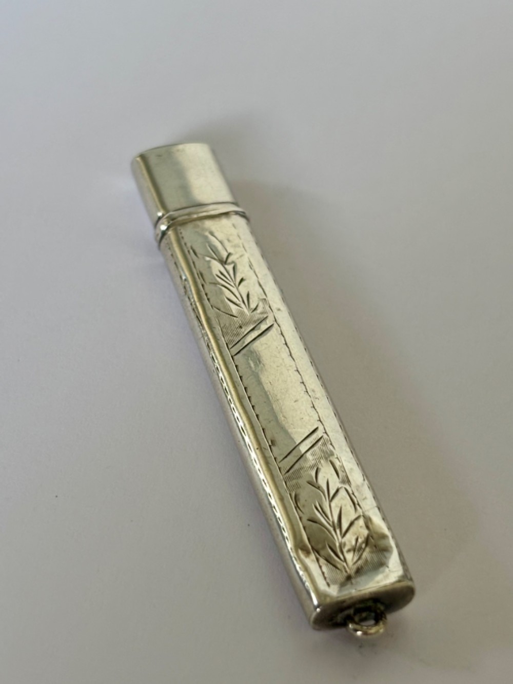 An engraved rectangular sterling silver pencil case featuring botanical foliage engraving and Chester hallmark stampings from 1918. View III