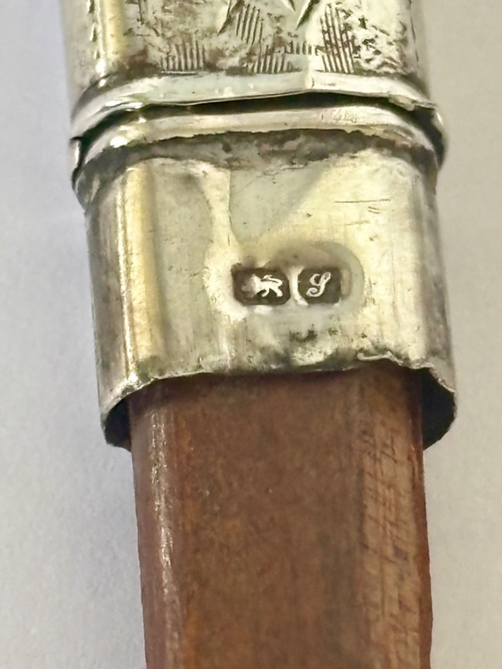 An engraved rectangular sterling silver pencil case featuring botanical foliage engraving and Chester hallmark stampings from 1918. View VIII