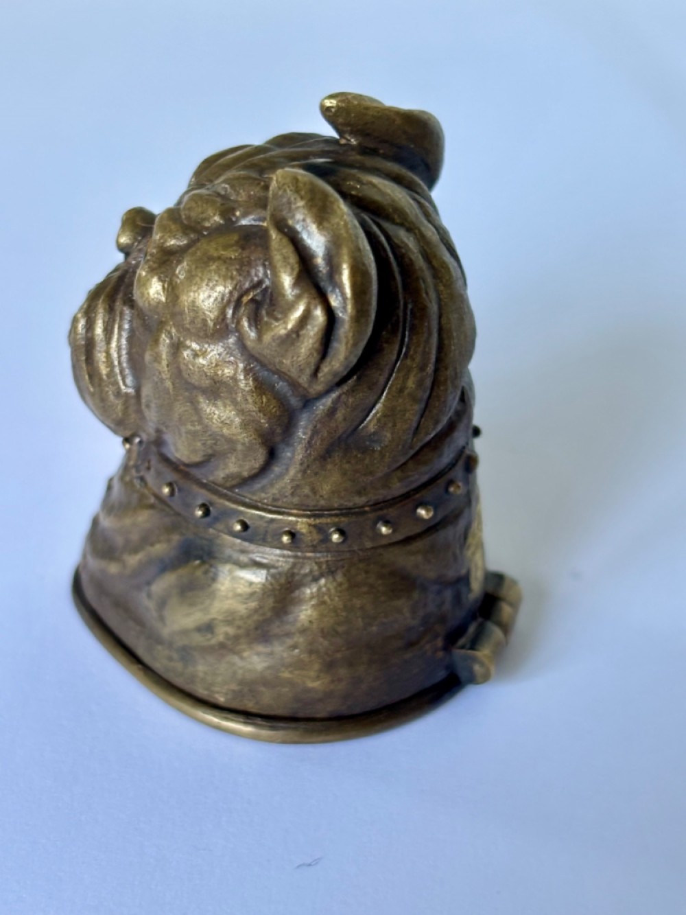 A cast brass table-top vesta case sculpted in the form of a bulldog head featuring inset yellow glass eyes and a studded collar. View II