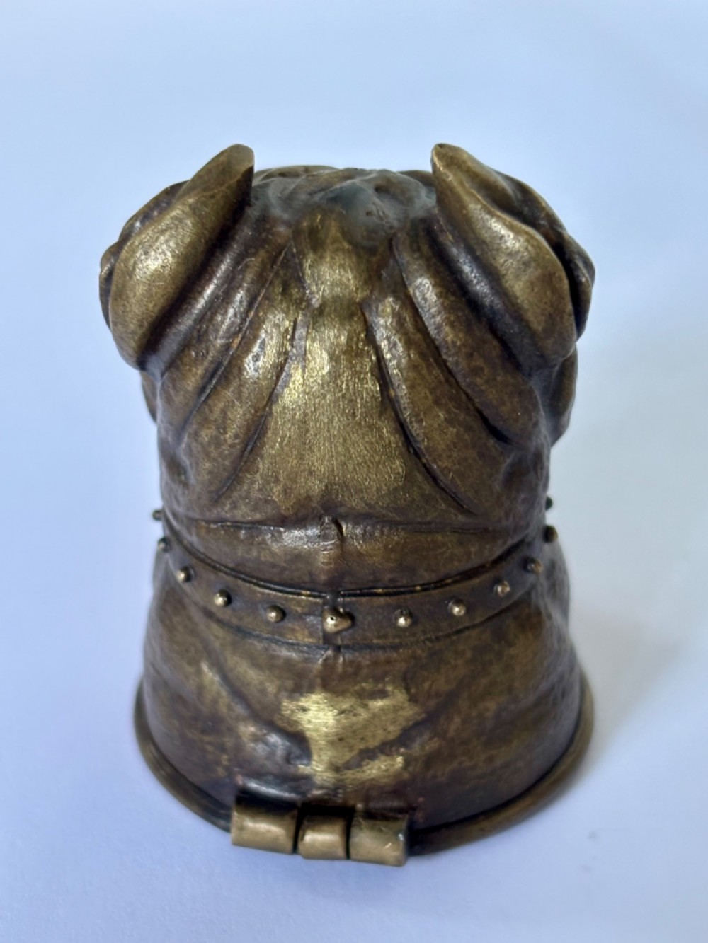 A cast brass table-top vesta case sculpted in the form of a bulldog head featuring inset yellow glass eyes and a studded collar. View III