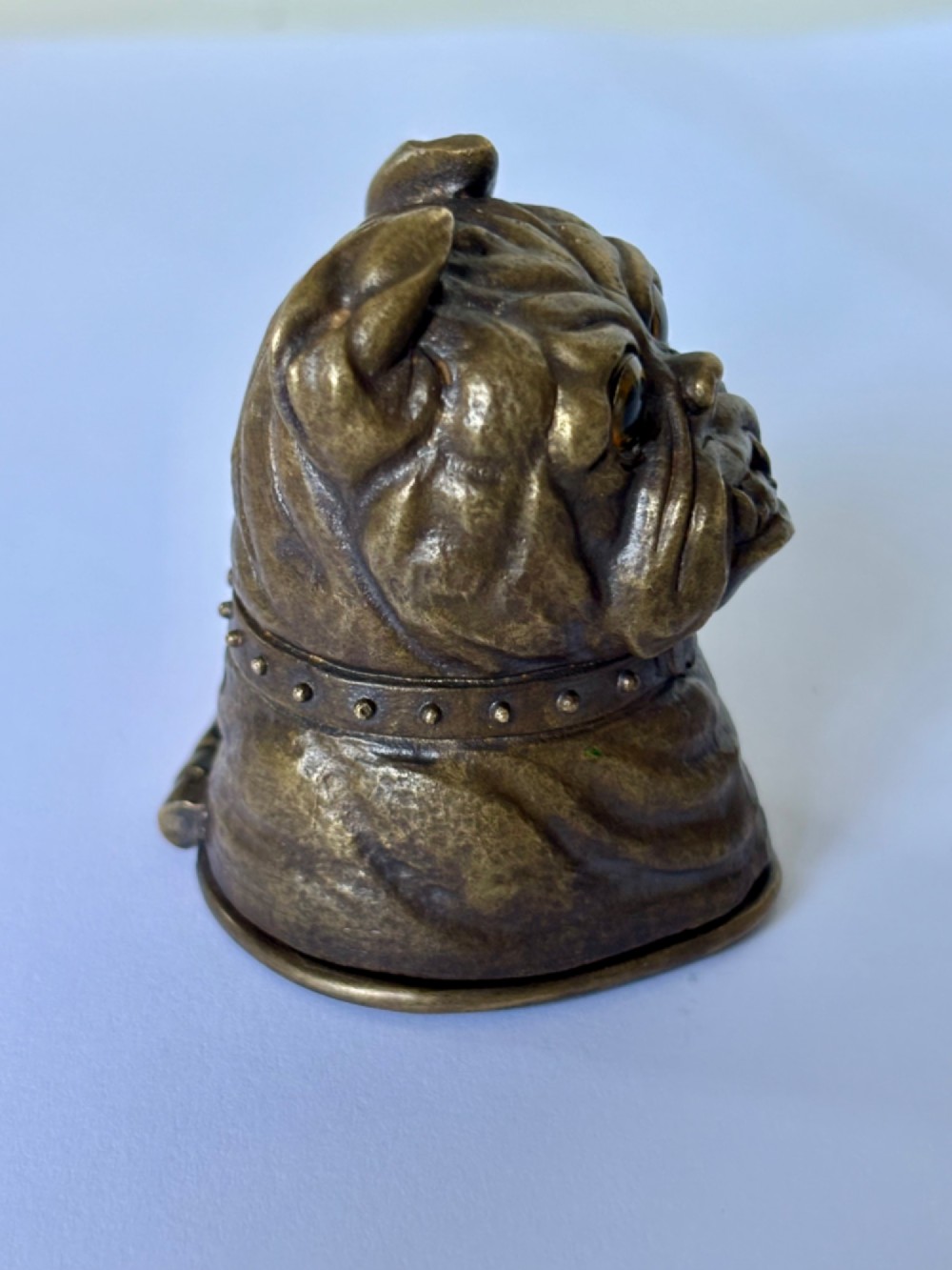 A cast brass table-top vesta case sculpted in the form of a bulldog head featuring inset yellow glass eyes and a studded collar. View IV