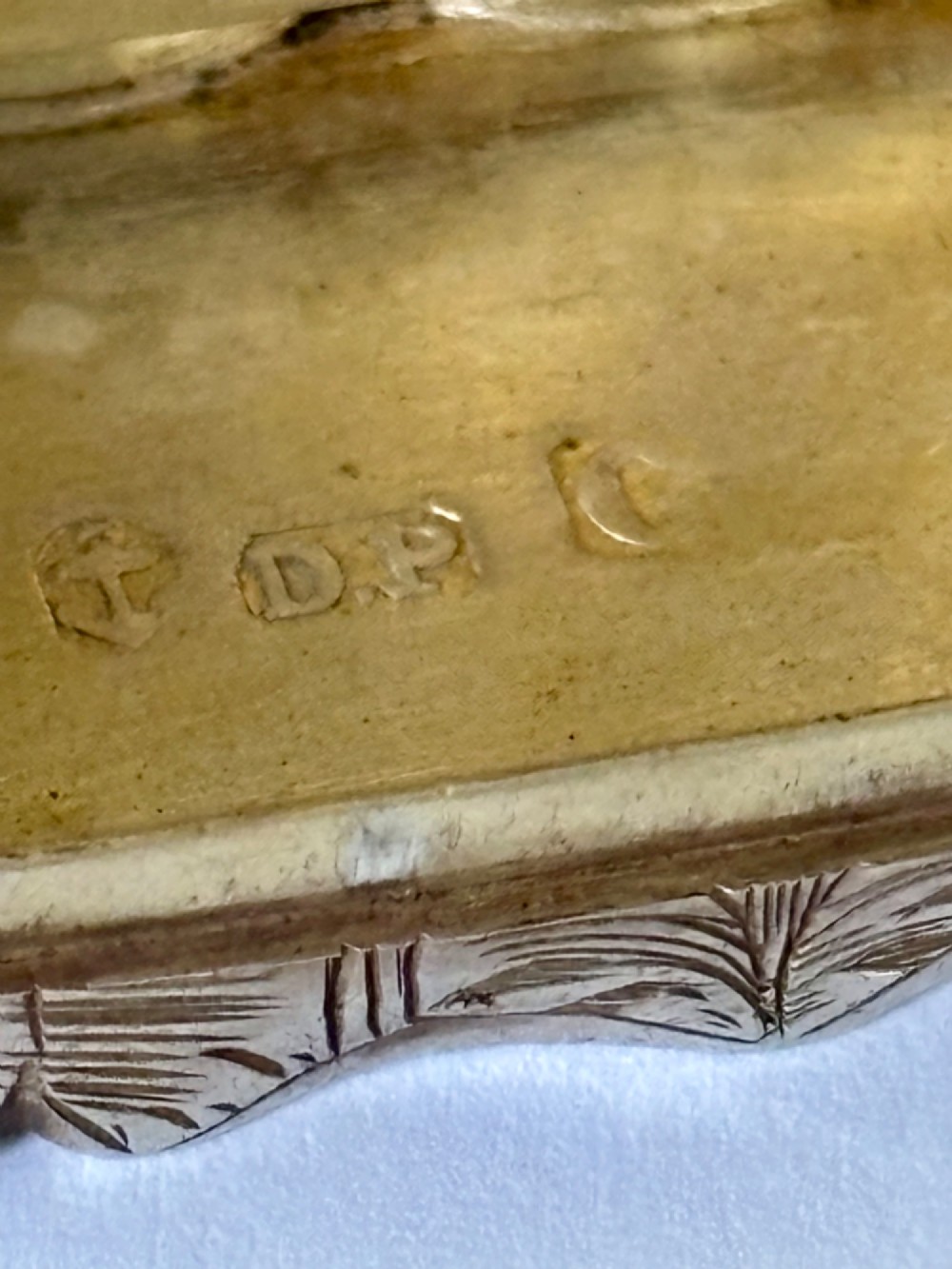 An open early Victorian rectangular silver-gilt vinaigrette showing hallmarks inside the lid and a detailed pierced foliate interior grille. View V
