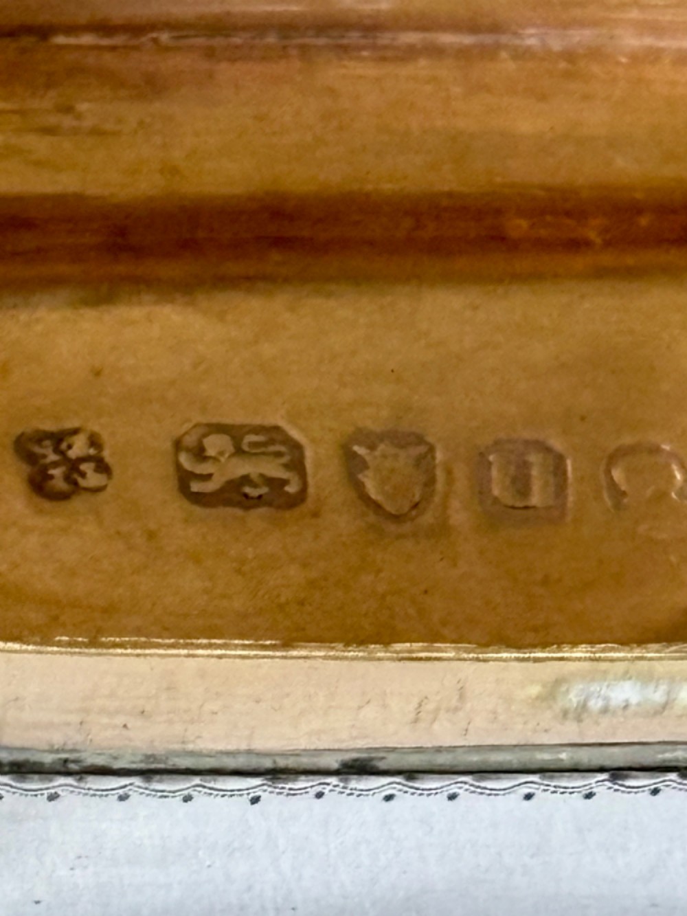 An octagonal Georgian sterling silver snuff box featuring bright-cut foliate engraving and an engraved central oval monogram. View VII