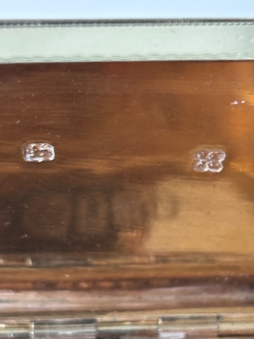 An octagonal Georgian sterling silver snuff box featuring bright-cut foliate engraving and an engraved central oval monogram. View VIII