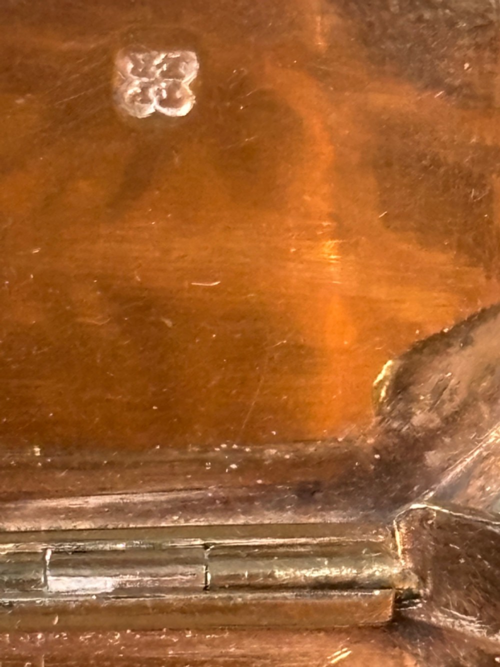 An octagonal Georgian sterling silver snuff box featuring bright-cut foliate engraving and an engraved central oval monogram. View IX