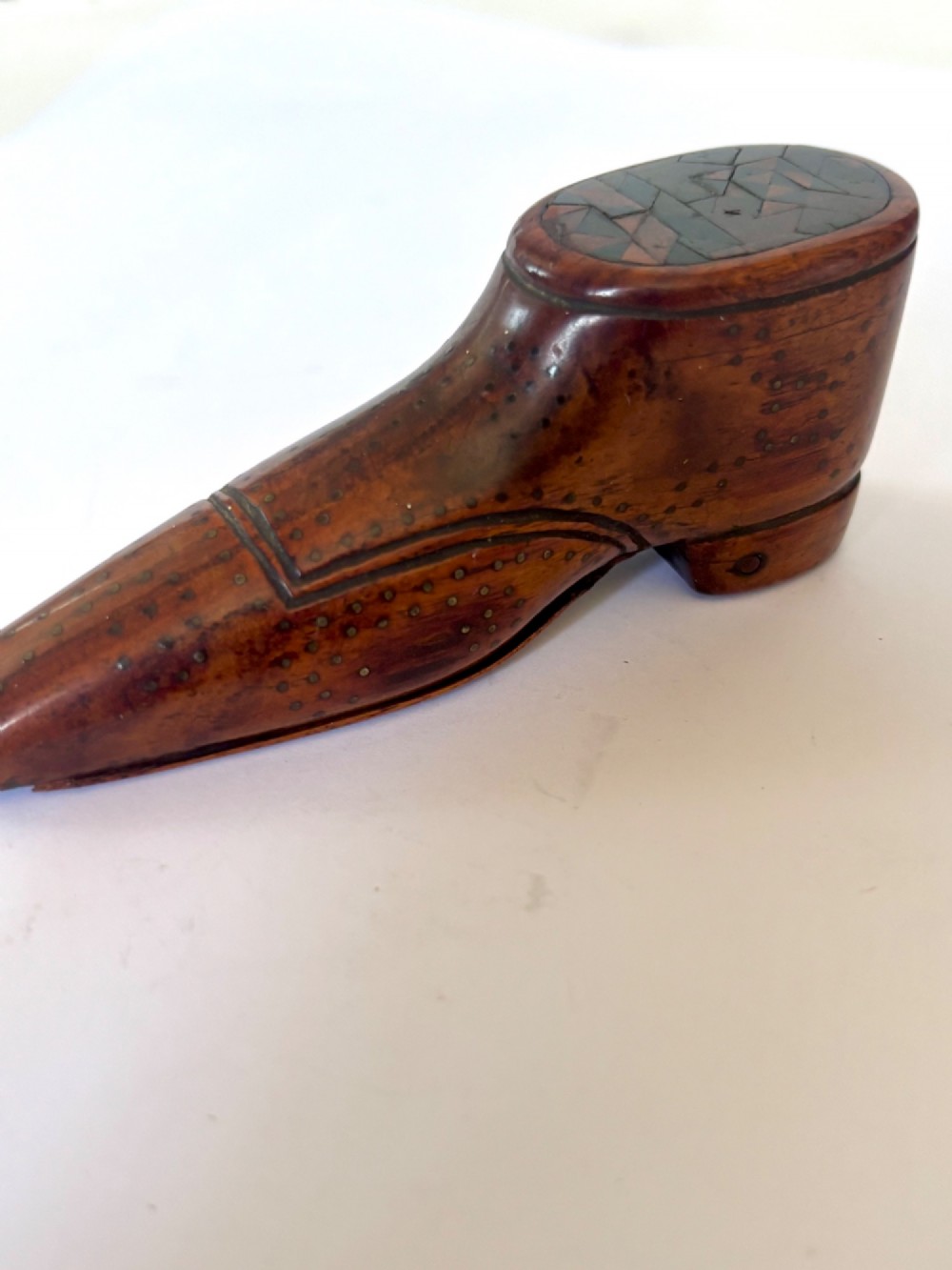 A 19th-century carved wooden shoe-form snuff box featuring brass pique pinwork and a geometric parquetry inlaid lid. View III