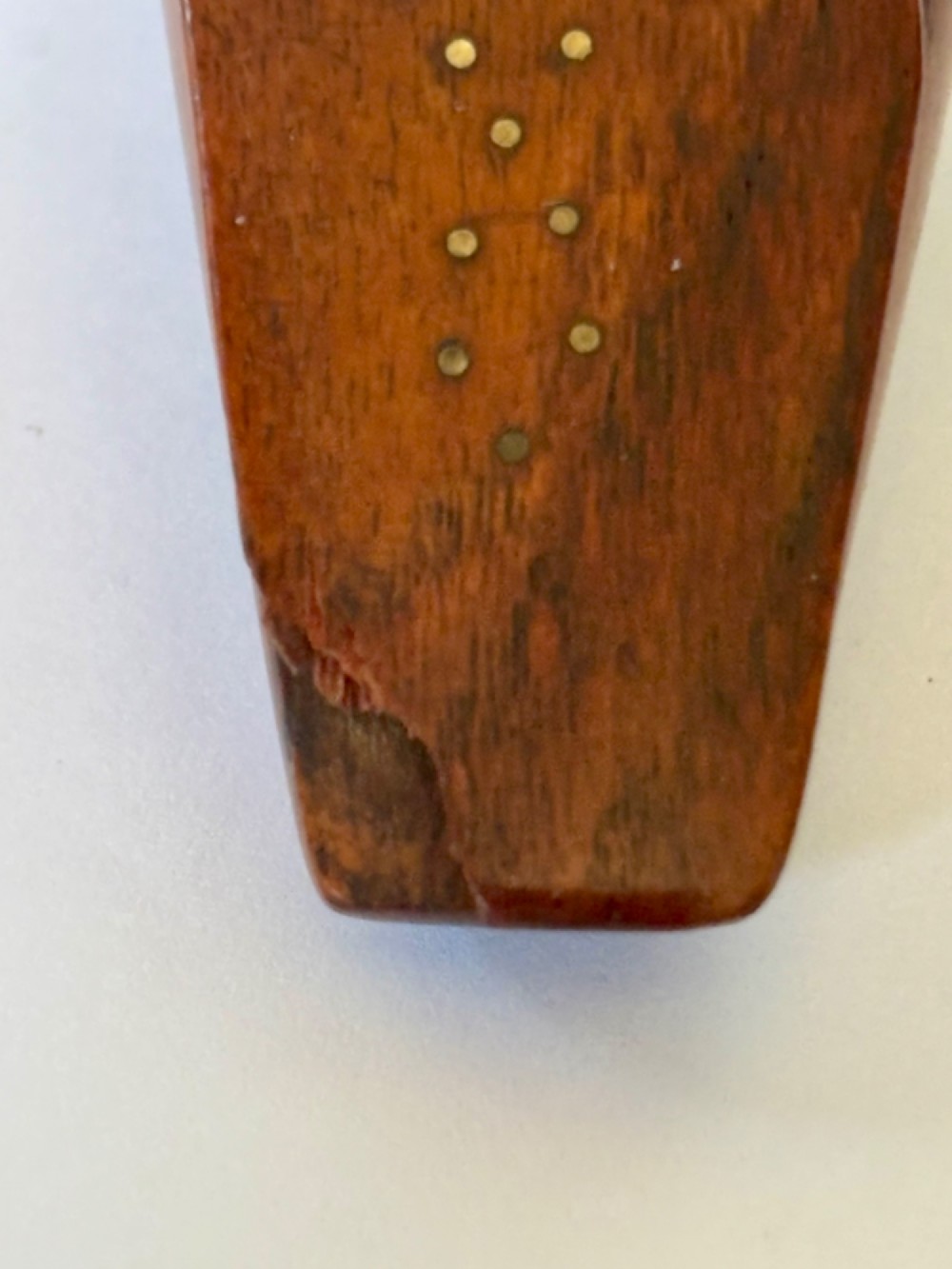A 19th-century carved wooden shoe-form snuff box featuring brass pique pinwork and a geometric parquetry inlaid lid. View VI