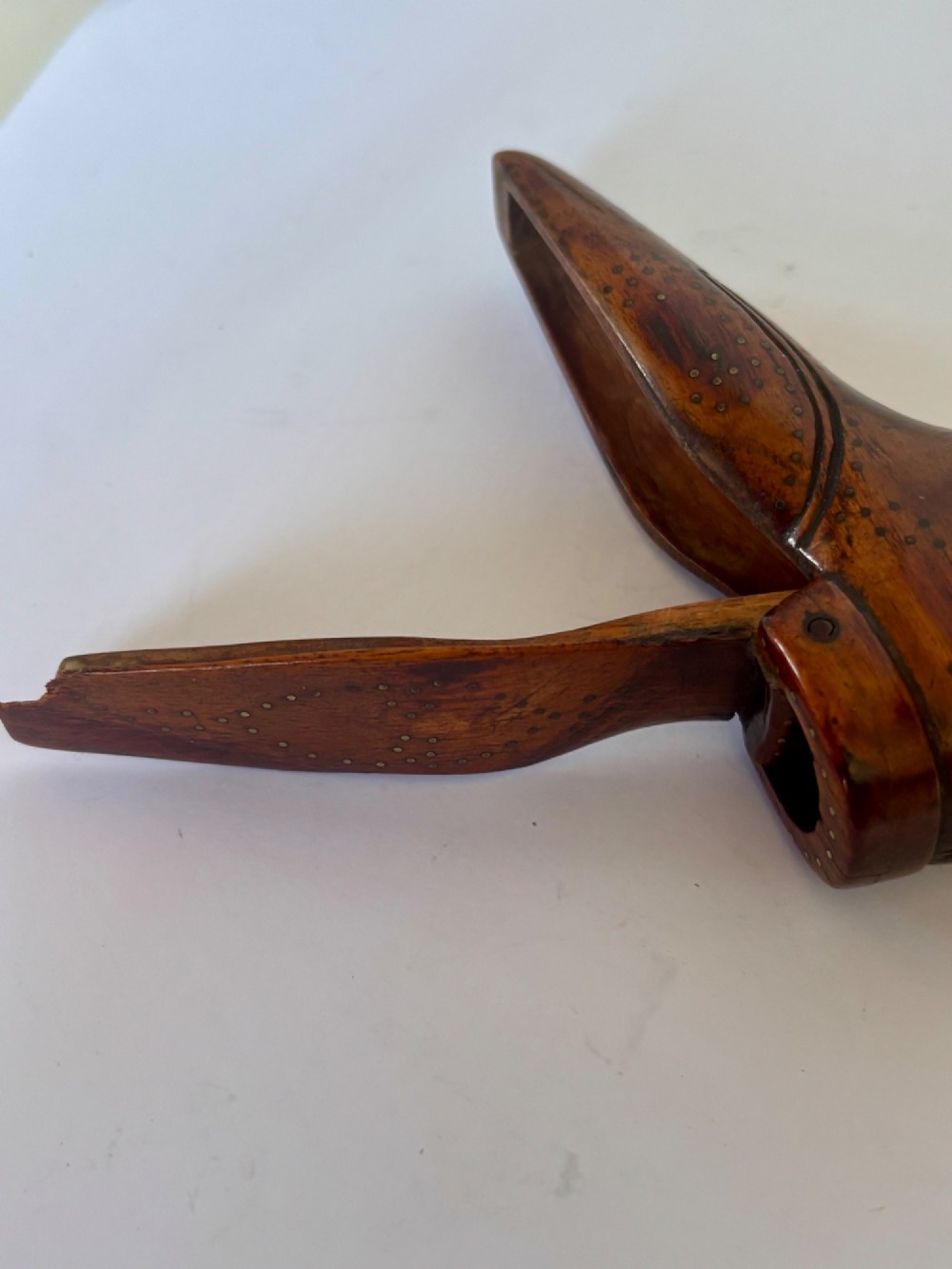 A 19th-century carved wooden shoe-form snuff box featuring brass pique pinwork and a geometric parquetry inlaid lid. View VIII
