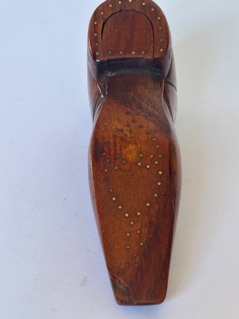 A 19th-century carved wooden shoe-form snuff box featuring brass pique pinwork and a geometric parquetry inlaid lid. View IX