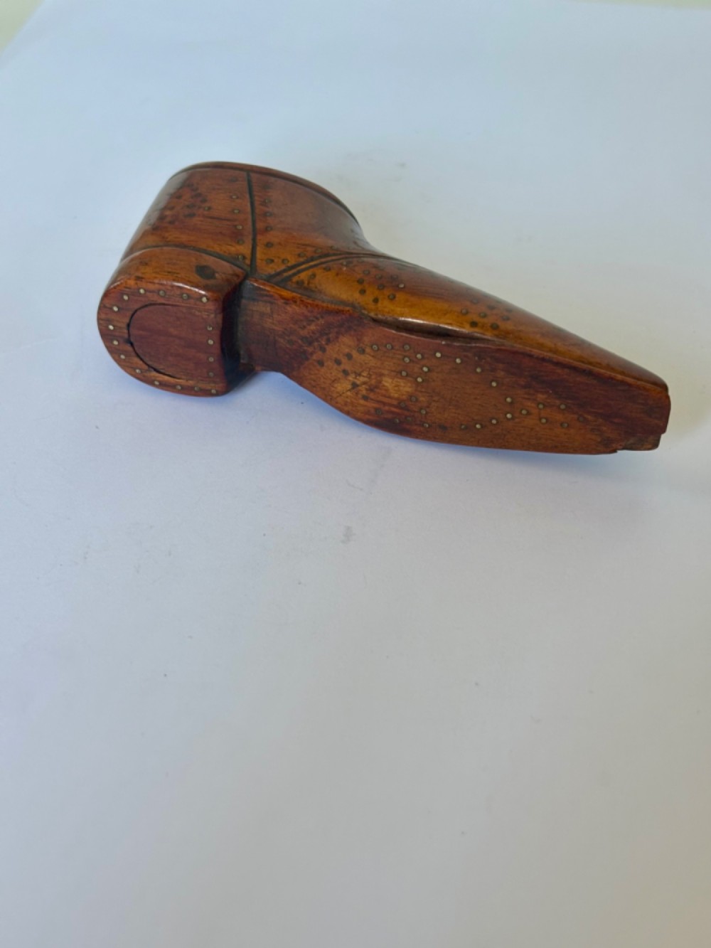 A 19th-century carved wooden shoe-form snuff box featuring brass pique pinwork and a geometric parquetry inlaid lid. View X