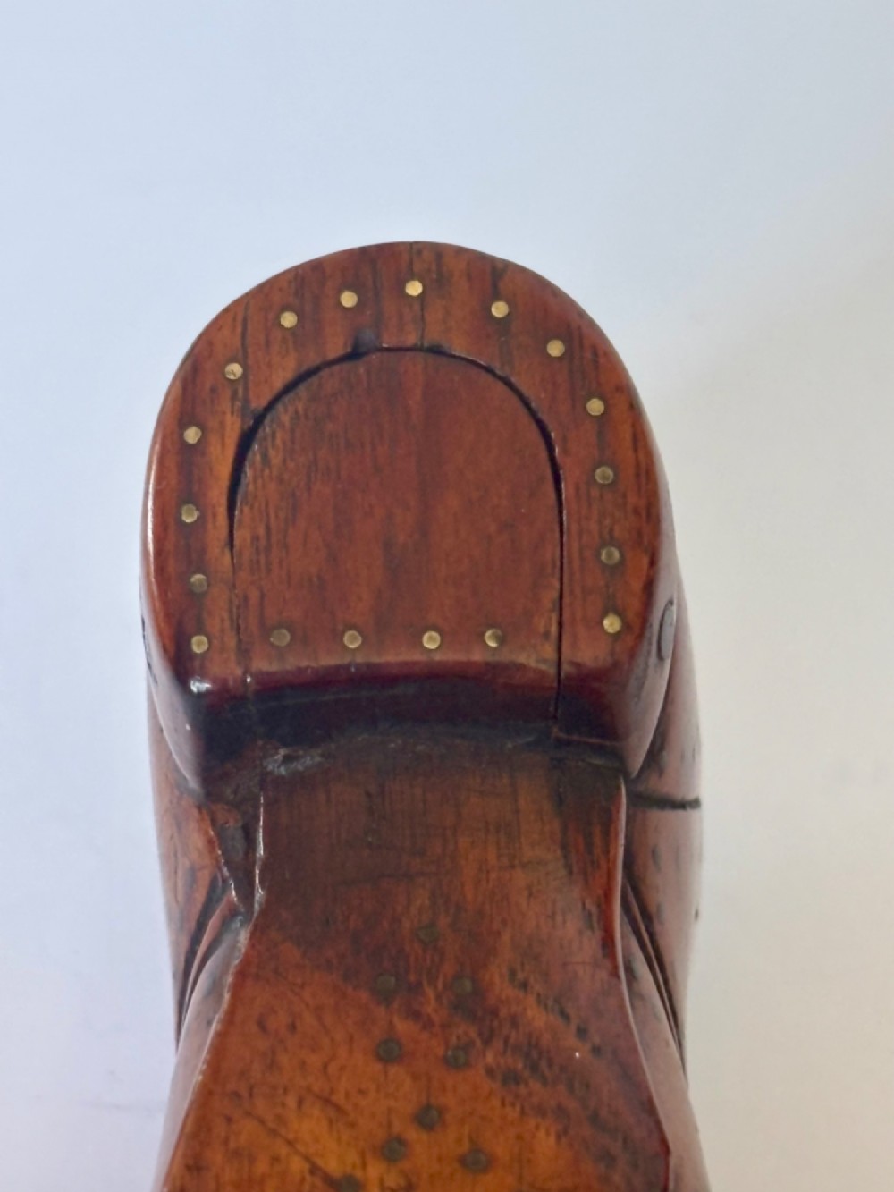 A 19th-century carved wooden shoe-form snuff box featuring brass pique pinwork and a geometric parquetry inlaid lid. View XI