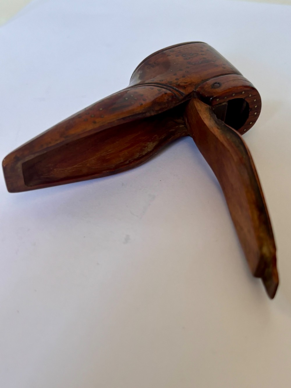 A 19th-century carved wooden shoe-form snuff box featuring brass pique pinwork and a geometric parquetry inlaid lid. View XII