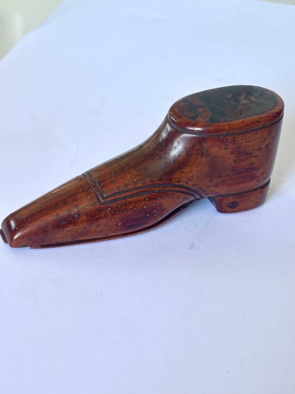 A 19th-century carved wooden shoe-form snuff box featuring brass pique pinwork and a geometric parquetry inlaid lid. View XIV