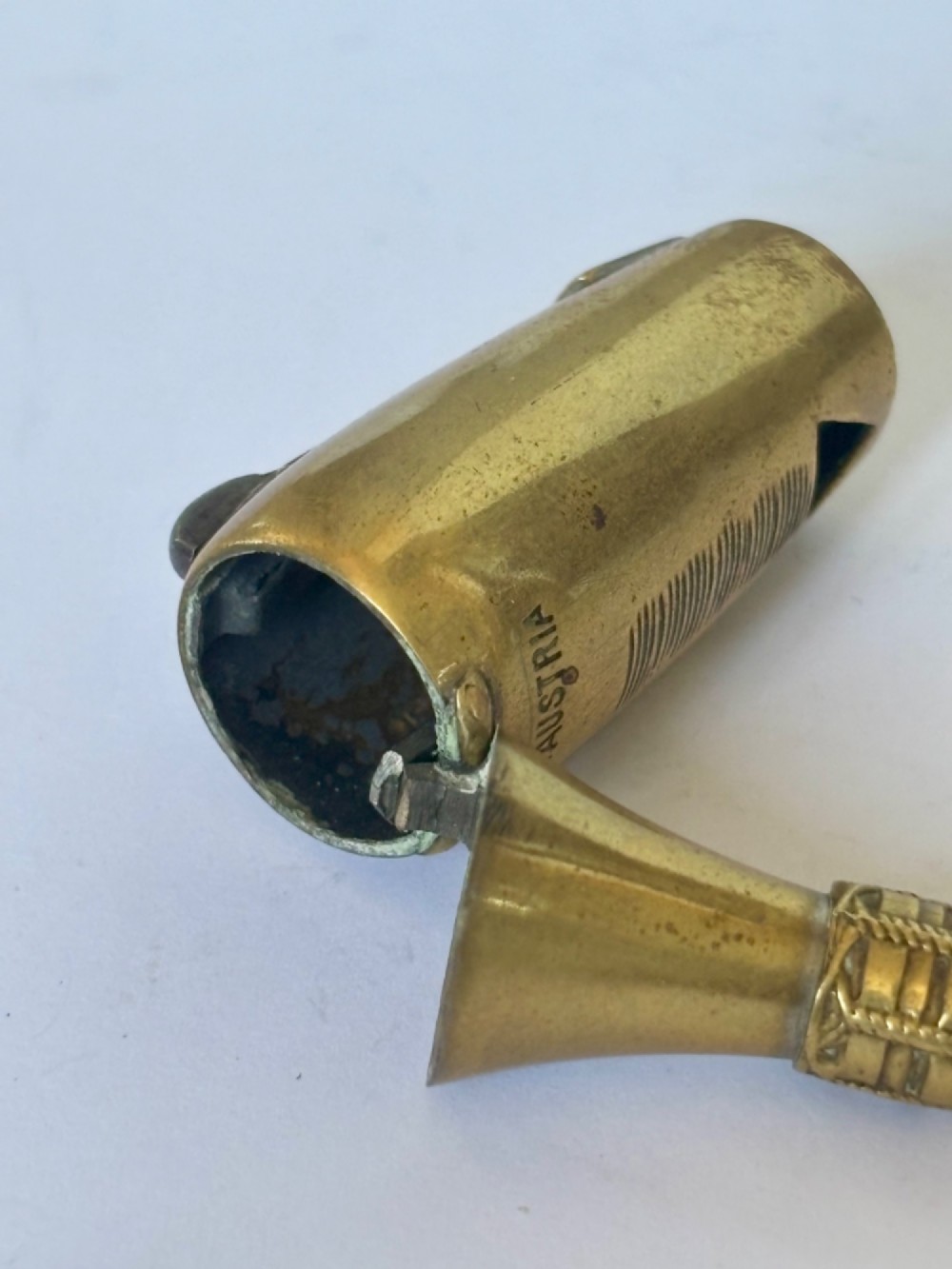 A nineteenth-century brass novelty vesta case and cigar cutter shaped like a champagne bottle with stamped Veuve Clicquot lettering. View II