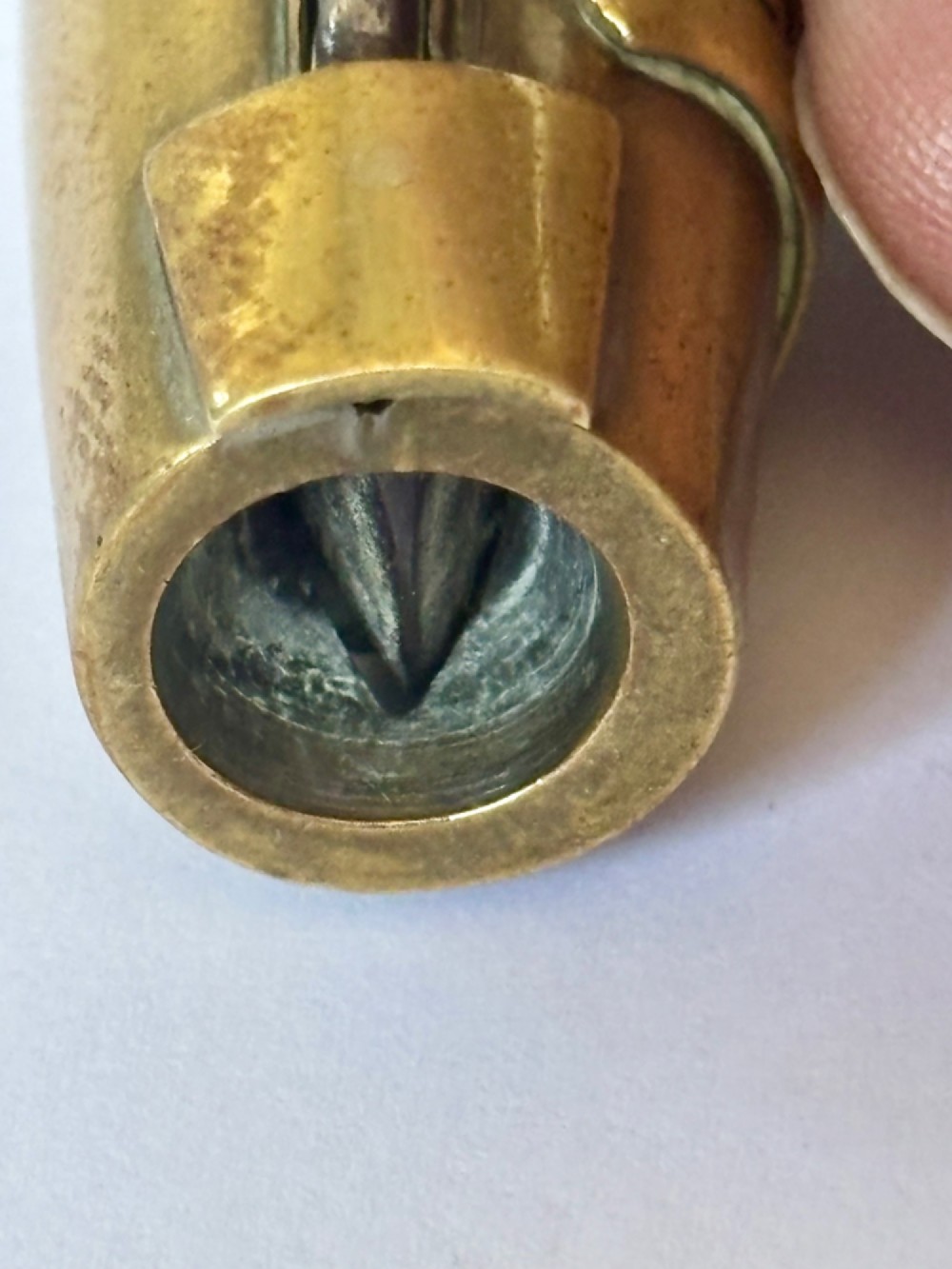 A nineteenth-century brass novelty vesta case and cigar cutter shaped like a champagne bottle with stamped Veuve Clicquot lettering. View VI