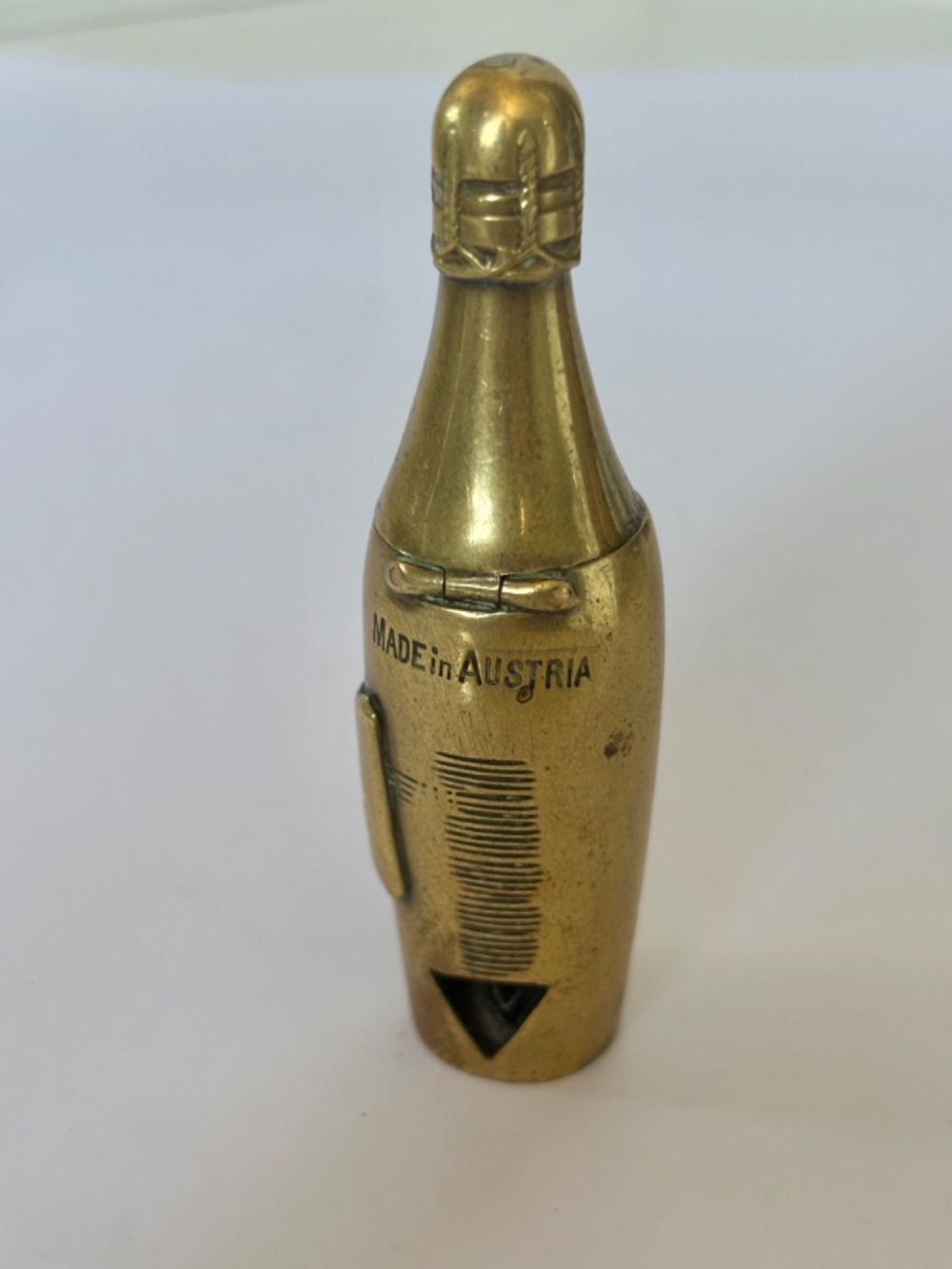 A nineteenth-century brass novelty vesta case and cigar cutter shaped like a champagne bottle with stamped Veuve Clicquot lettering. View IX