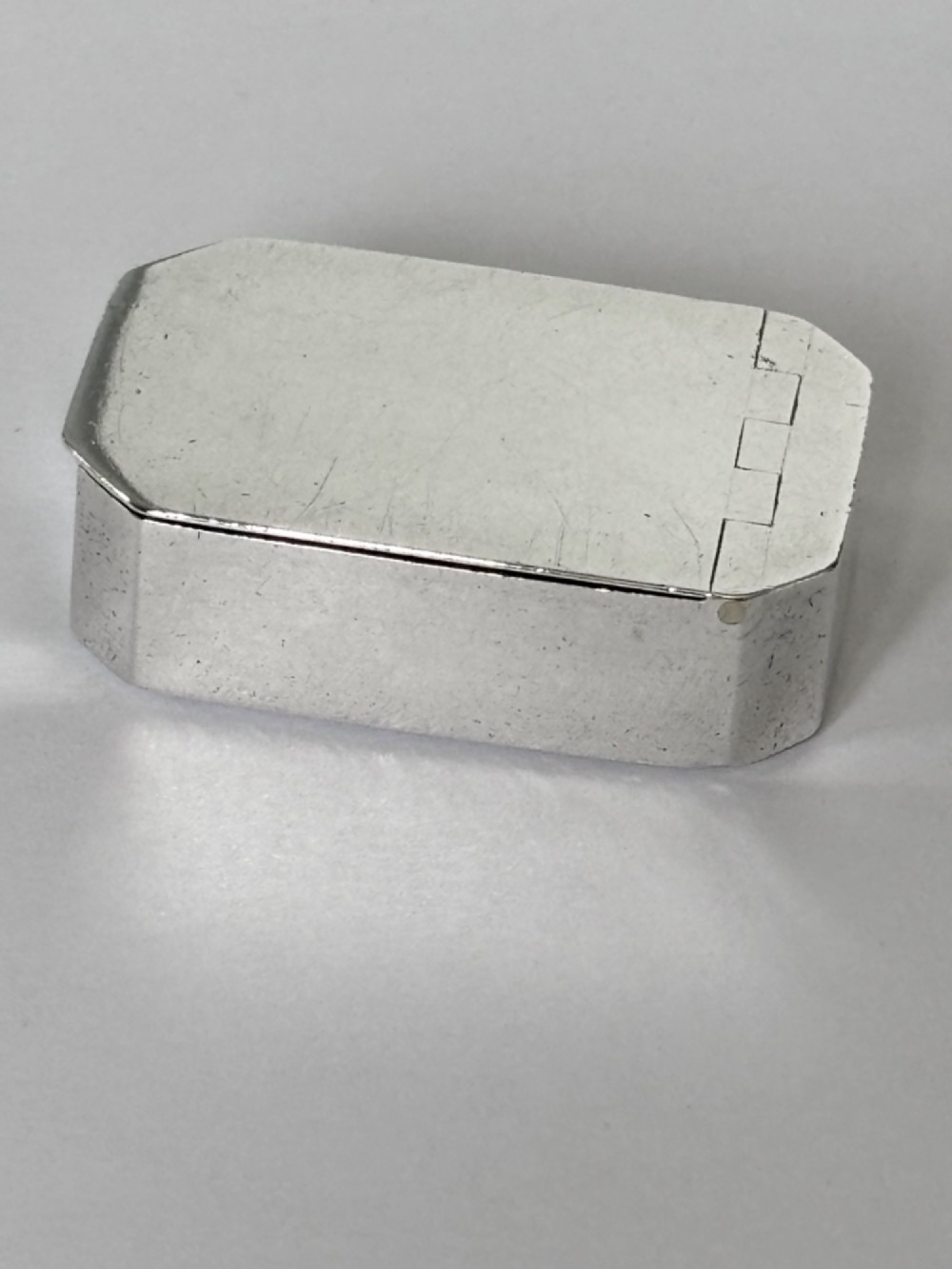 An 18th-century Georgian sterling silver pocket snuff box featuring canted corners and a flush integrated hinge. View II