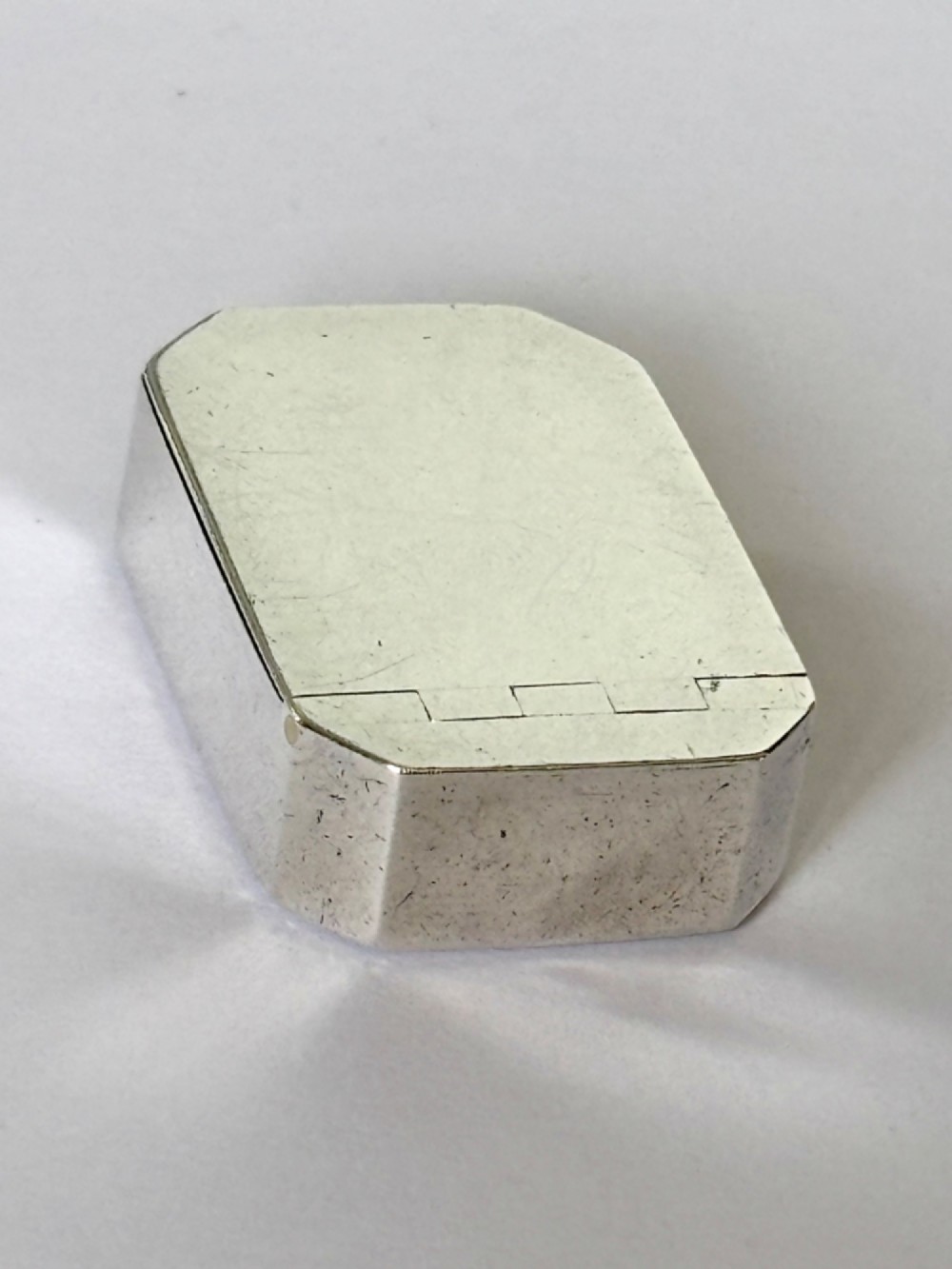 An 18th-century Georgian sterling silver pocket snuff box featuring canted corners and a flush integrated hinge. View III