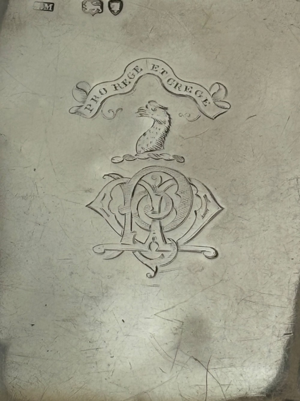 A Victorian sterling silver hip flask featuring an engraved crest, family monogram, and official British silver hallmarks. View III