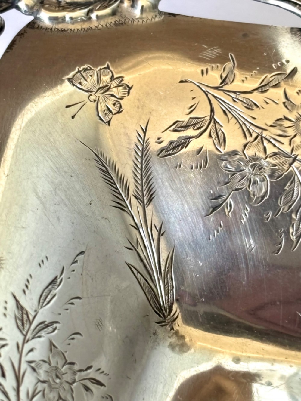 A pair of rectangular Edwardian sterling silver trinket dishes featuring pierced scrollwork borders and engraved floral decoration. View XI