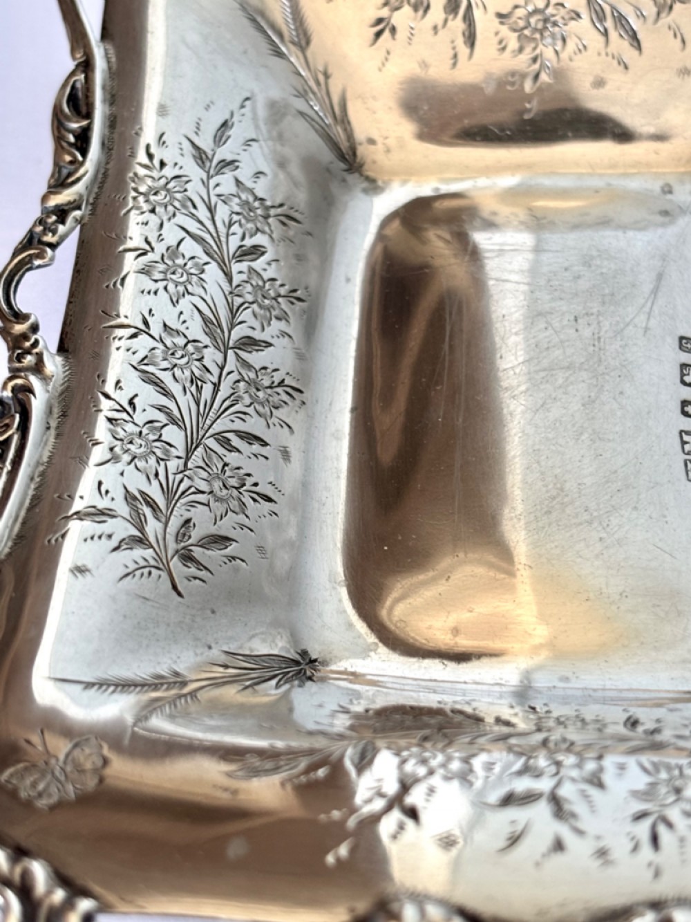 A pair of rectangular Edwardian sterling silver trinket dishes featuring pierced scrollwork borders and engraved floral decoration. View XII