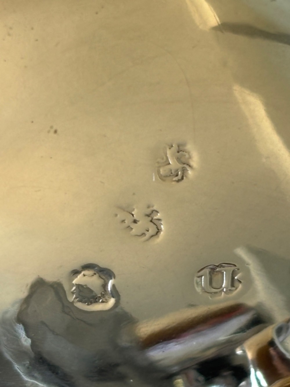 A pair of round 18th-century sterling silver open salt cellars with cobalt blue glass liners, raised on three hoof feet. View XI