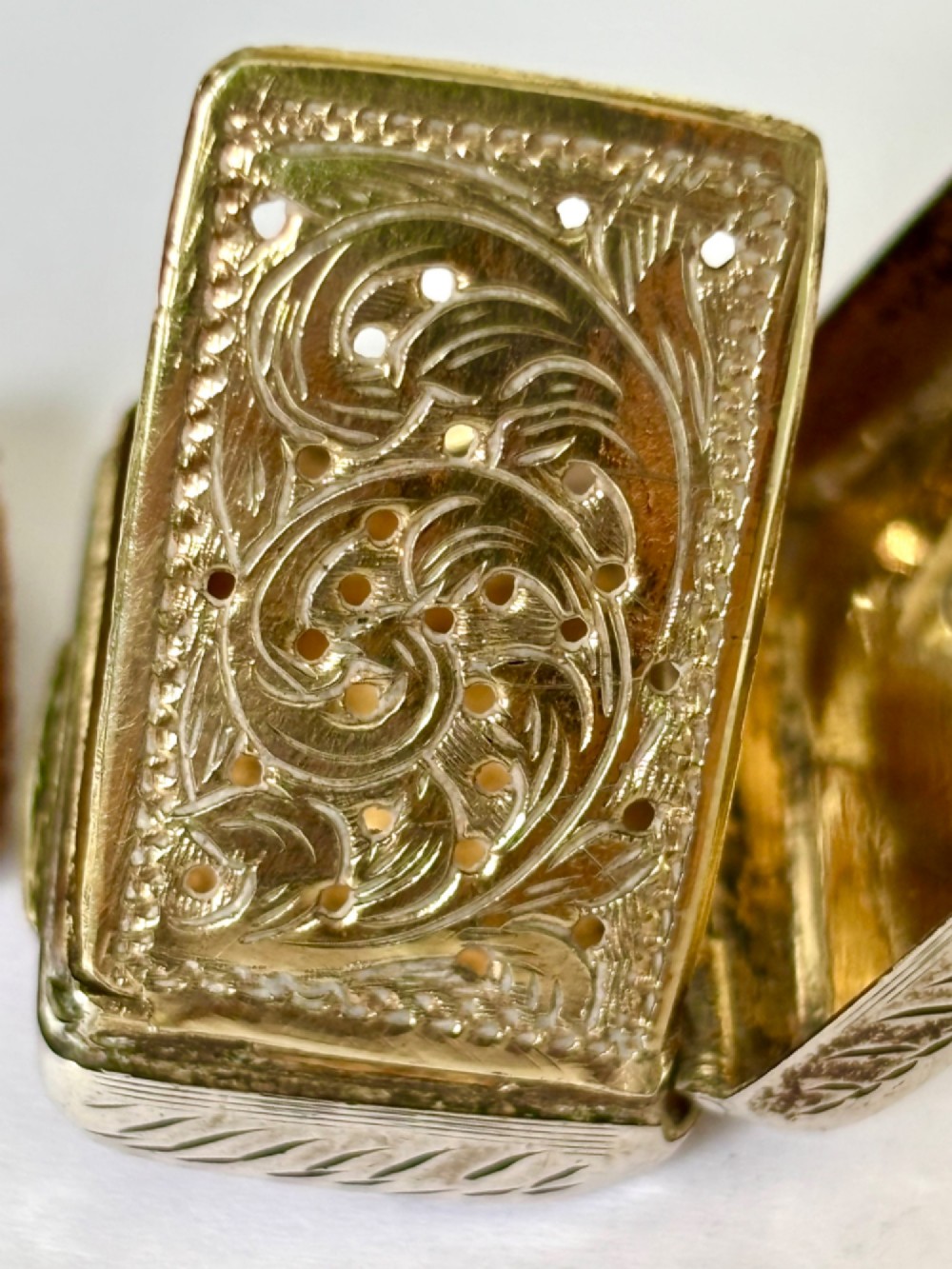 An early Victorian rectangular sterling silver vinaigrette featuring intricate foliate scroll engraving and a central unengraved cartouche. View VIII