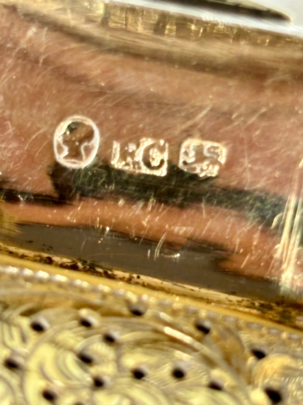 An early Victorian rectangular sterling silver vinaigrette featuring intricate foliate scroll engraving and a central unengraved cartouche. View XII