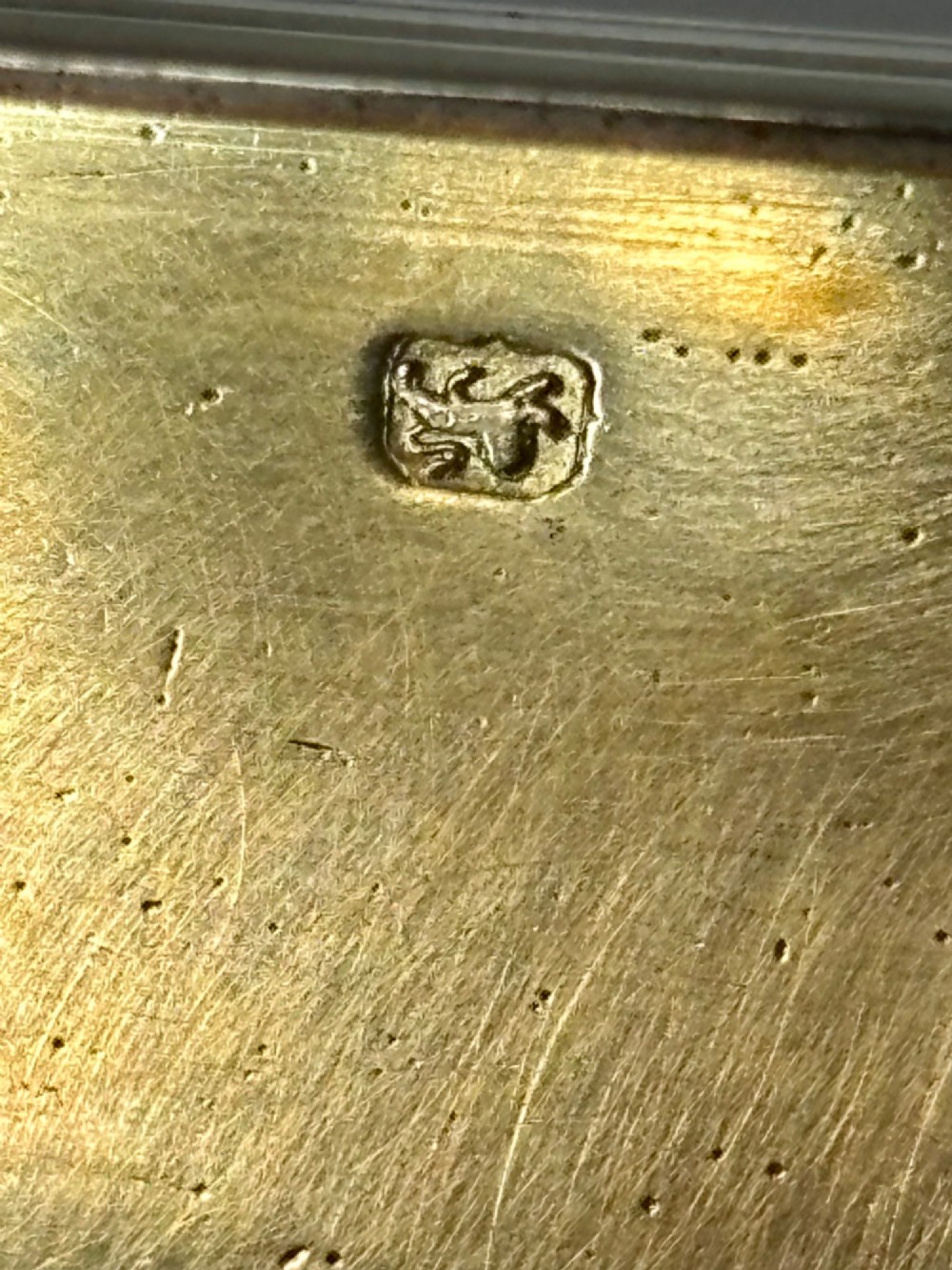 An elongated Georgian sterling silver snuff box with rounded ends, engraved on the lid with the Isle of Man triskelion crest. View VIII