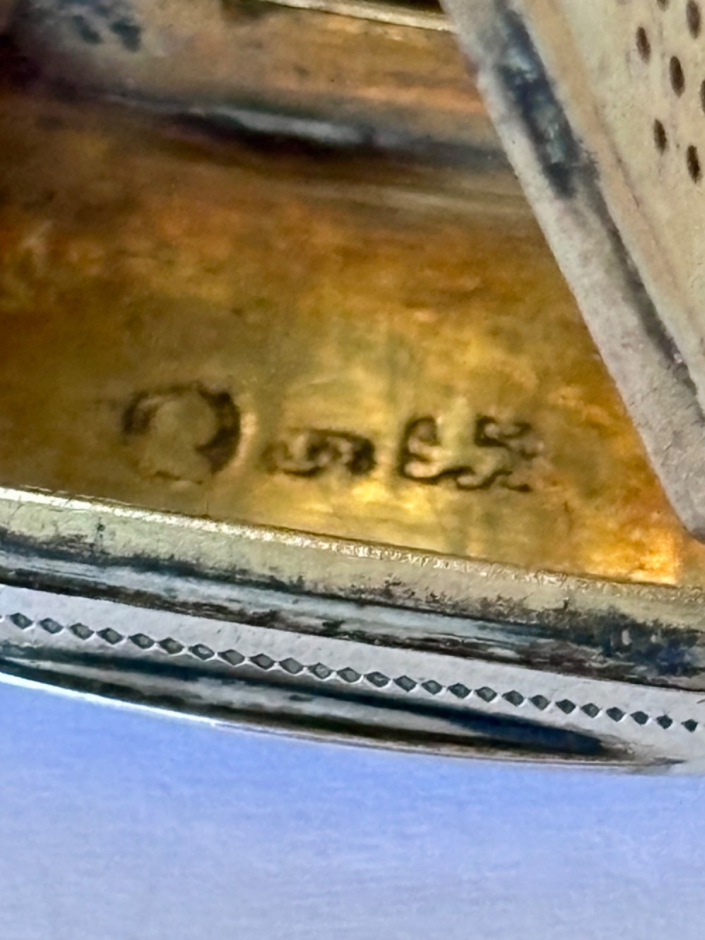 A small rectangular Georgian silver vinaigrette box with hand-engraved wrigglework patterns and a plain central oval cartouche. View VI