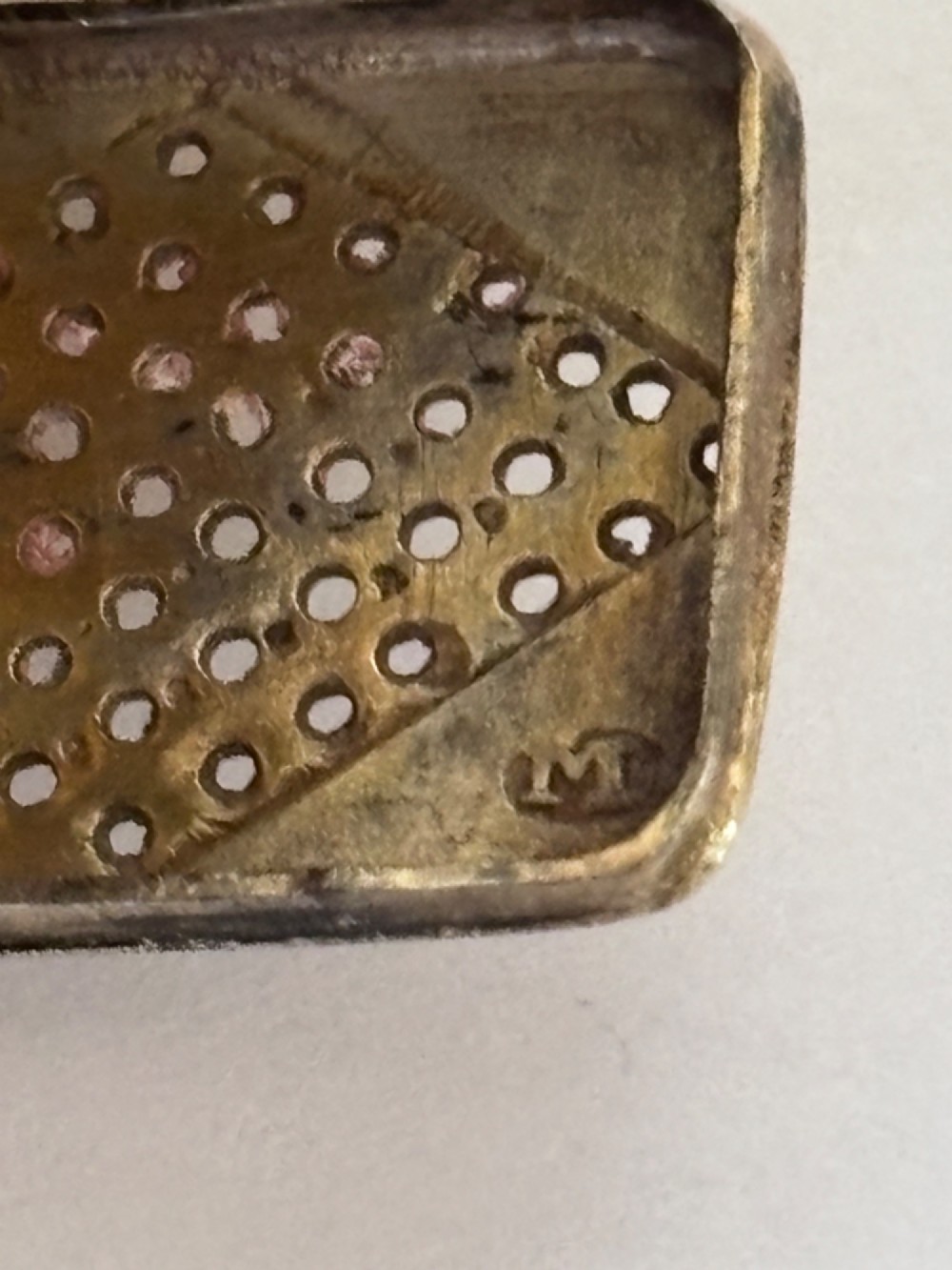 A small rectangular Georgian silver vinaigrette box with hand-engraved wrigglework patterns and a plain central oval cartouche. View VII