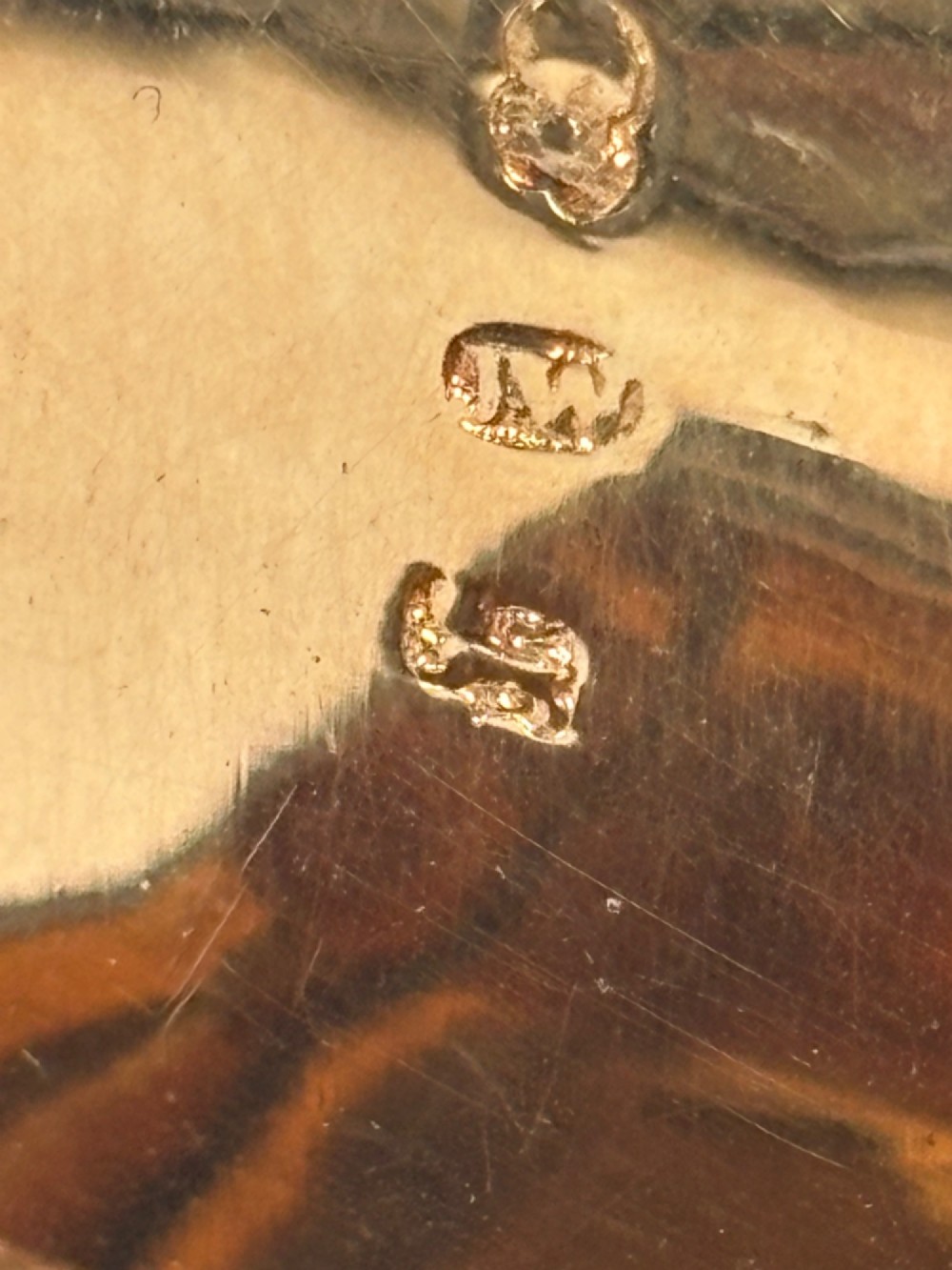 A curved antique sterling silver pocket snuff box featuring elaborate hand engraving and a flush hinge. View XI
