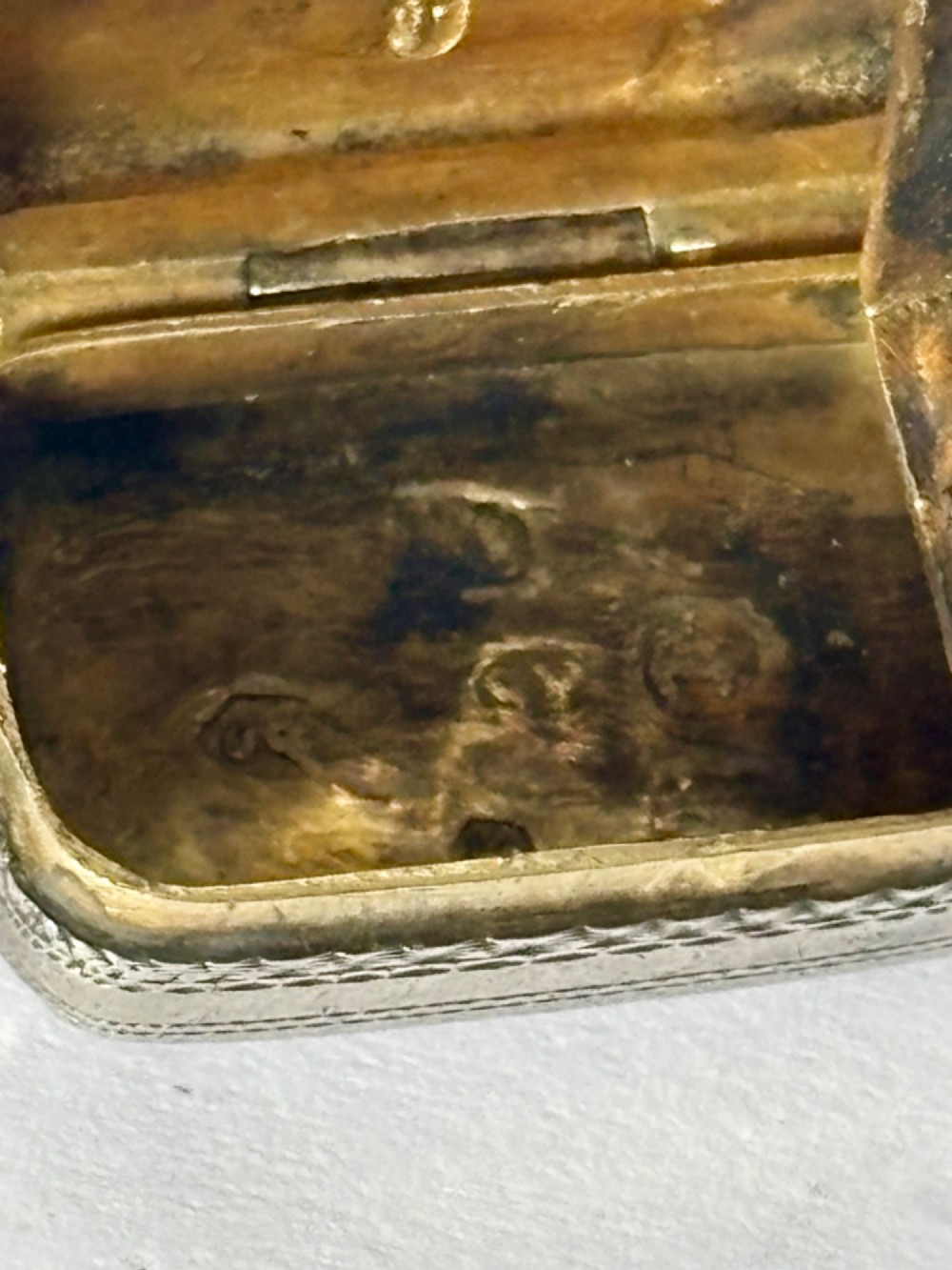 A small rectangular Georgian silver vinaigrette featuring intricate floral engraving, textured background patterns, and an attached suspension ring. View VI