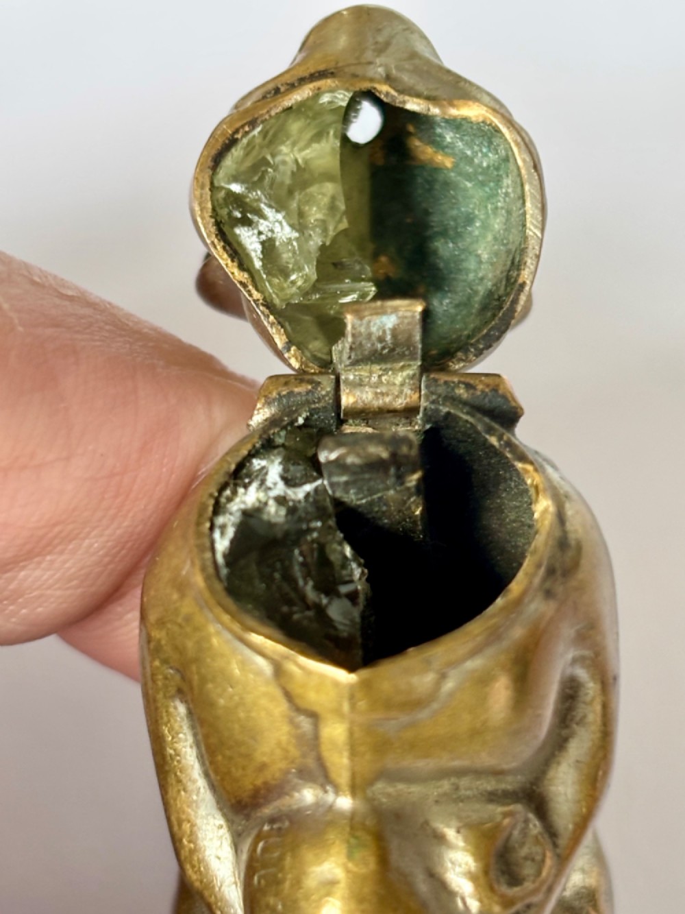 A small antique cast brass vesta case formed in the shape of a pig sitting upright. View IX