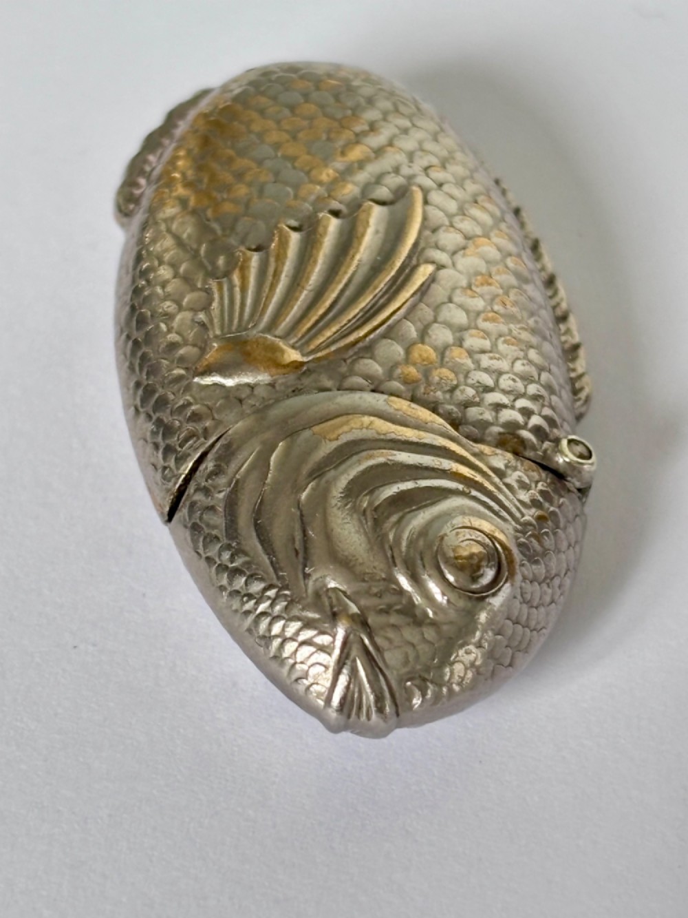 A silver-plated brass vesta case cast in the shape of a carp with detailed body scales and a hinged head. View IV