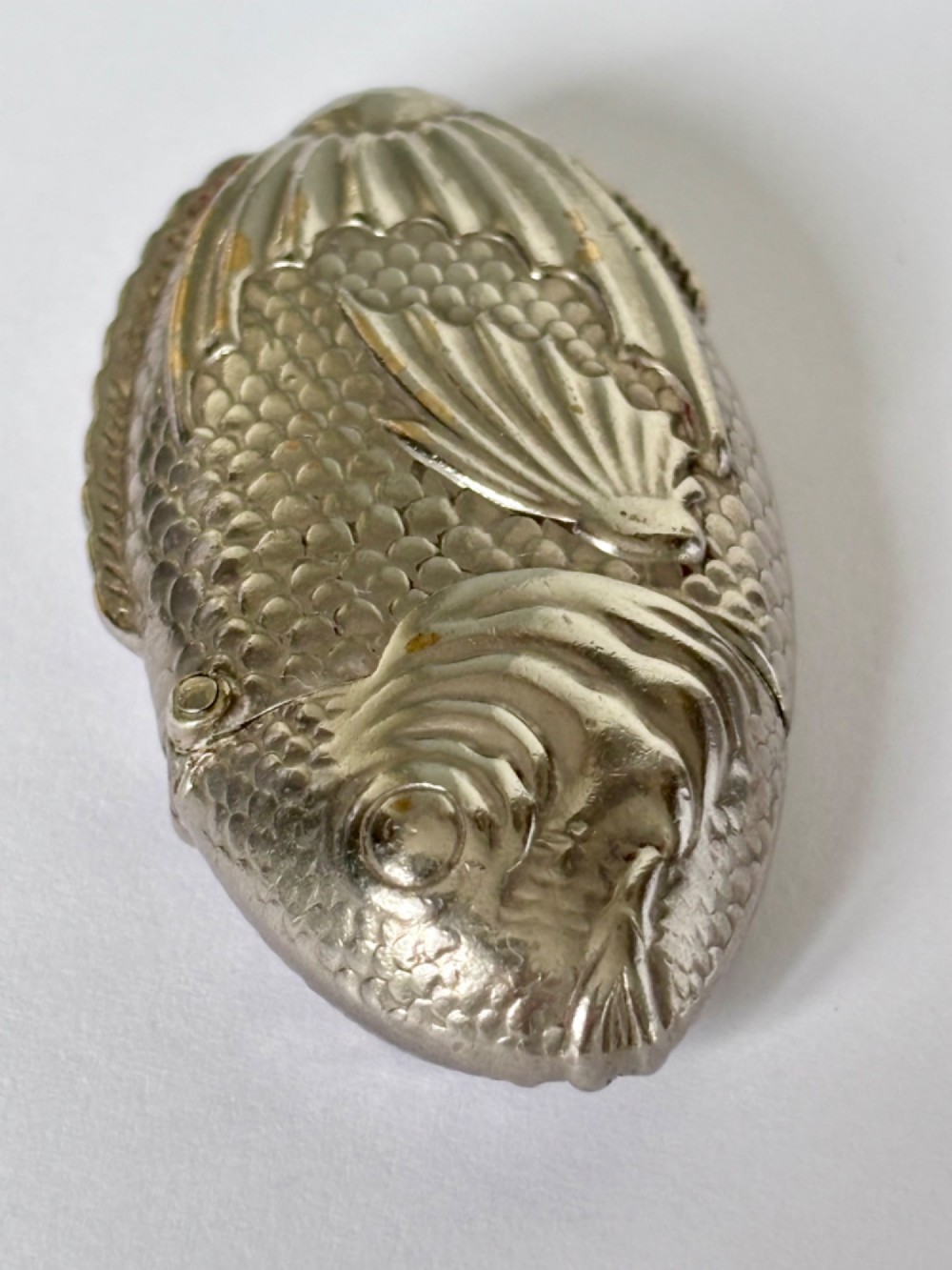 A silver-plated brass vesta case cast in the shape of a carp with detailed body scales and a hinged head. View V