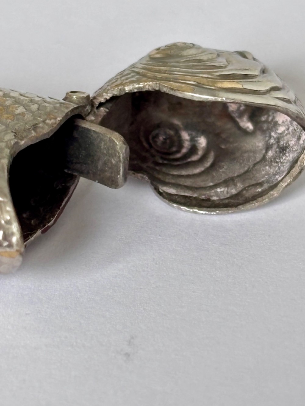 A silver-plated brass vesta case cast in the shape of a carp with detailed body scales and a hinged head. View VI
