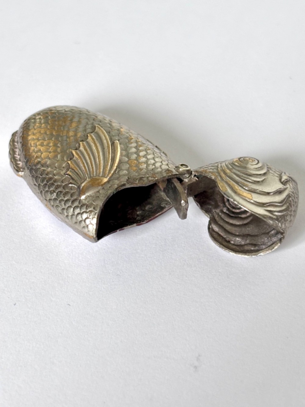 A silver-plated brass vesta case cast in the shape of a carp with detailed body scales and a hinged head. View VIII