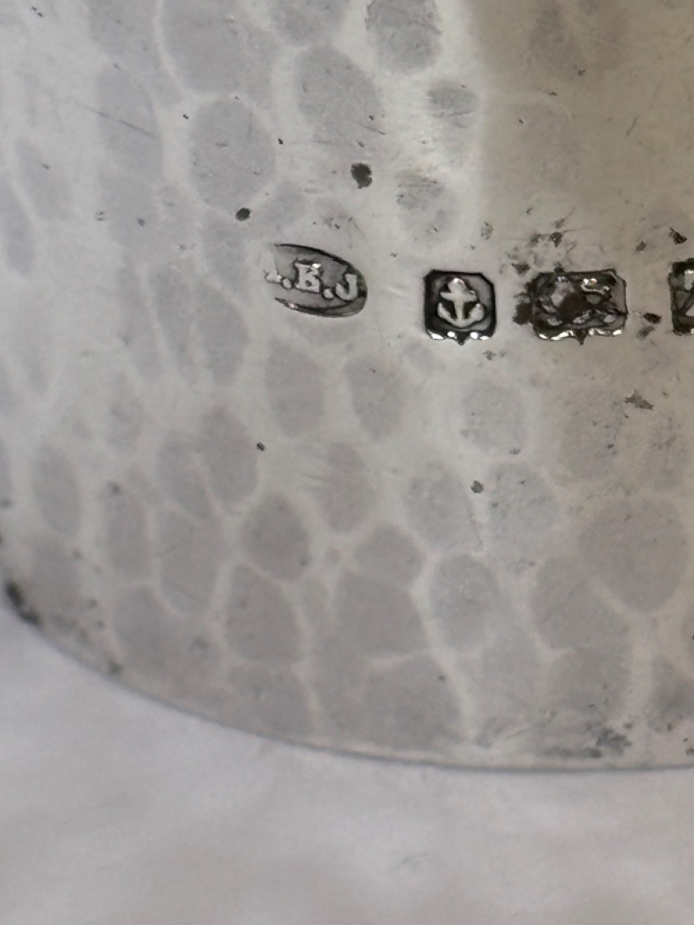 A wide, cylindrical sterling silver napkin ring featuring a hand-hammered planished surface finish. View III